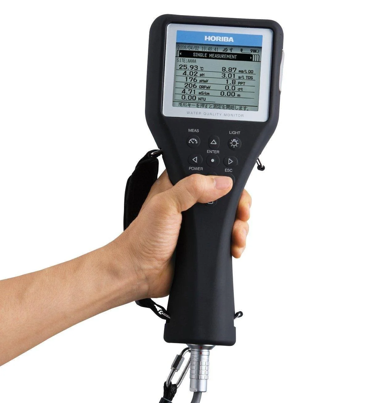 A person holding a handheld water quality testing device with a digital display showing water parameter readings.