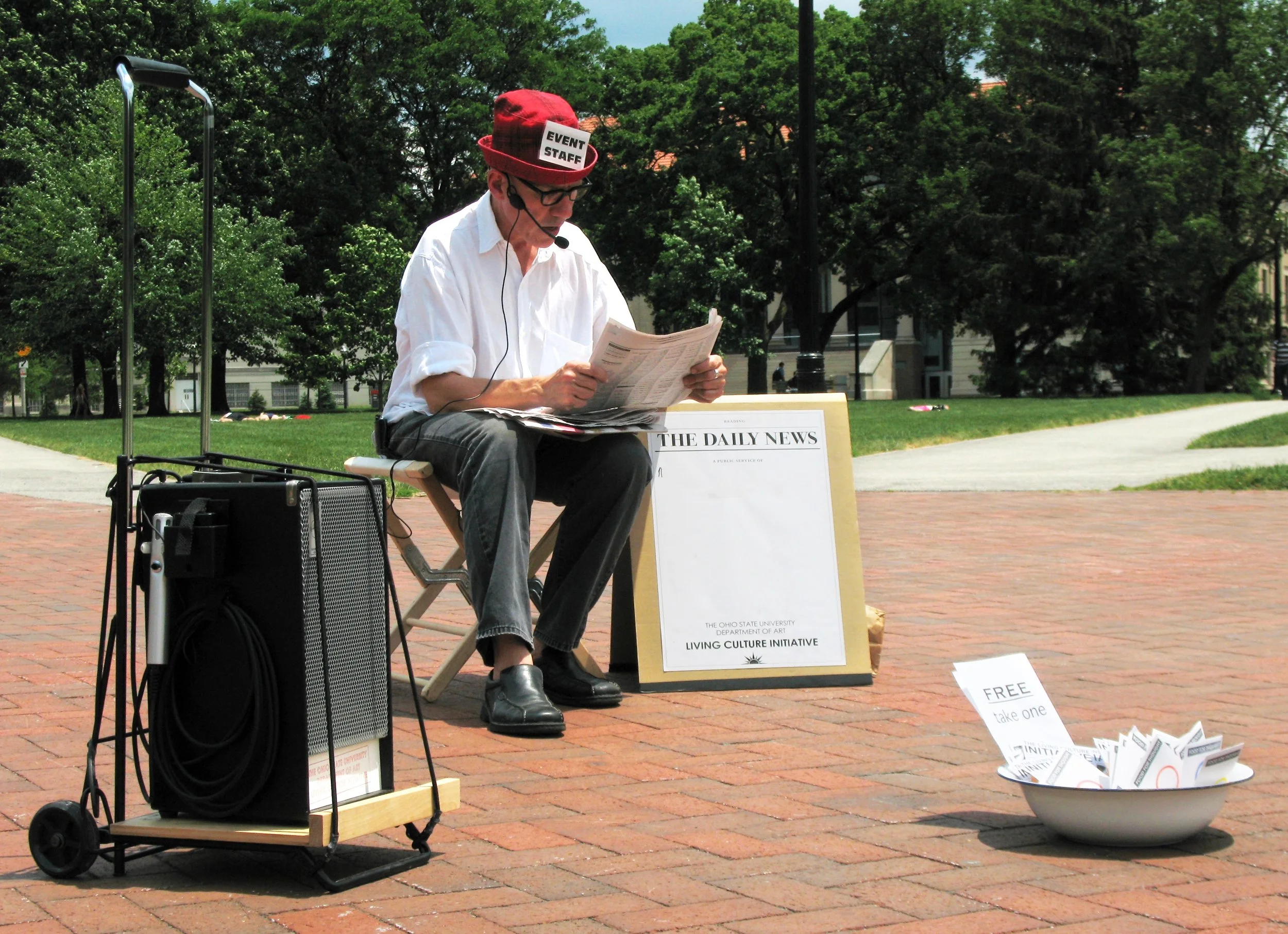 Michael Mercil, Reading the Daily News, or 365 days for Lucio Pozzi , 2008-ongoing; physical and time dimensions vary; reader, newspaper, portable audio system; courtesy the artist