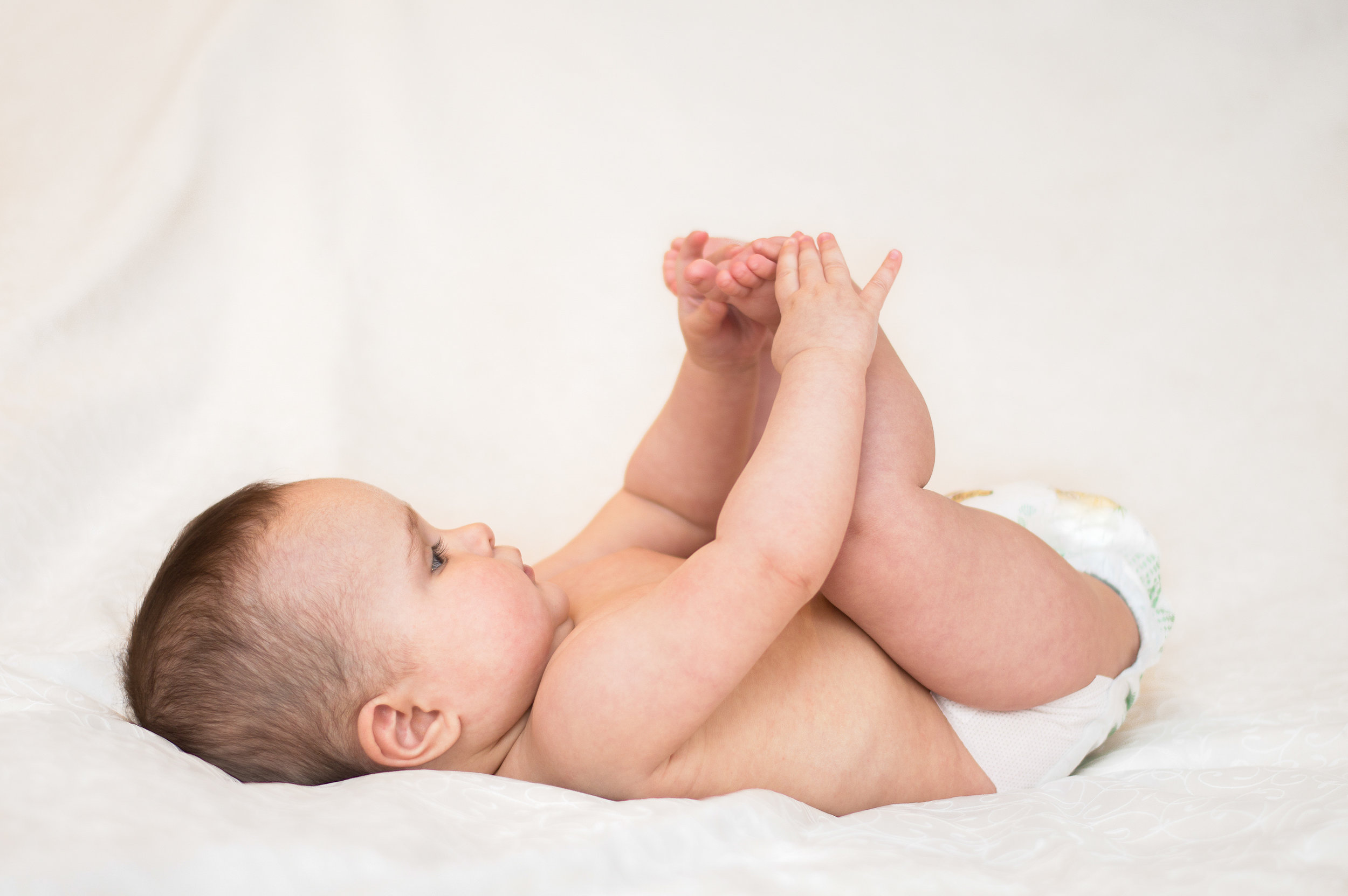 baby-is-playing-with-her-feet-481562070_3000x1995.jpeg