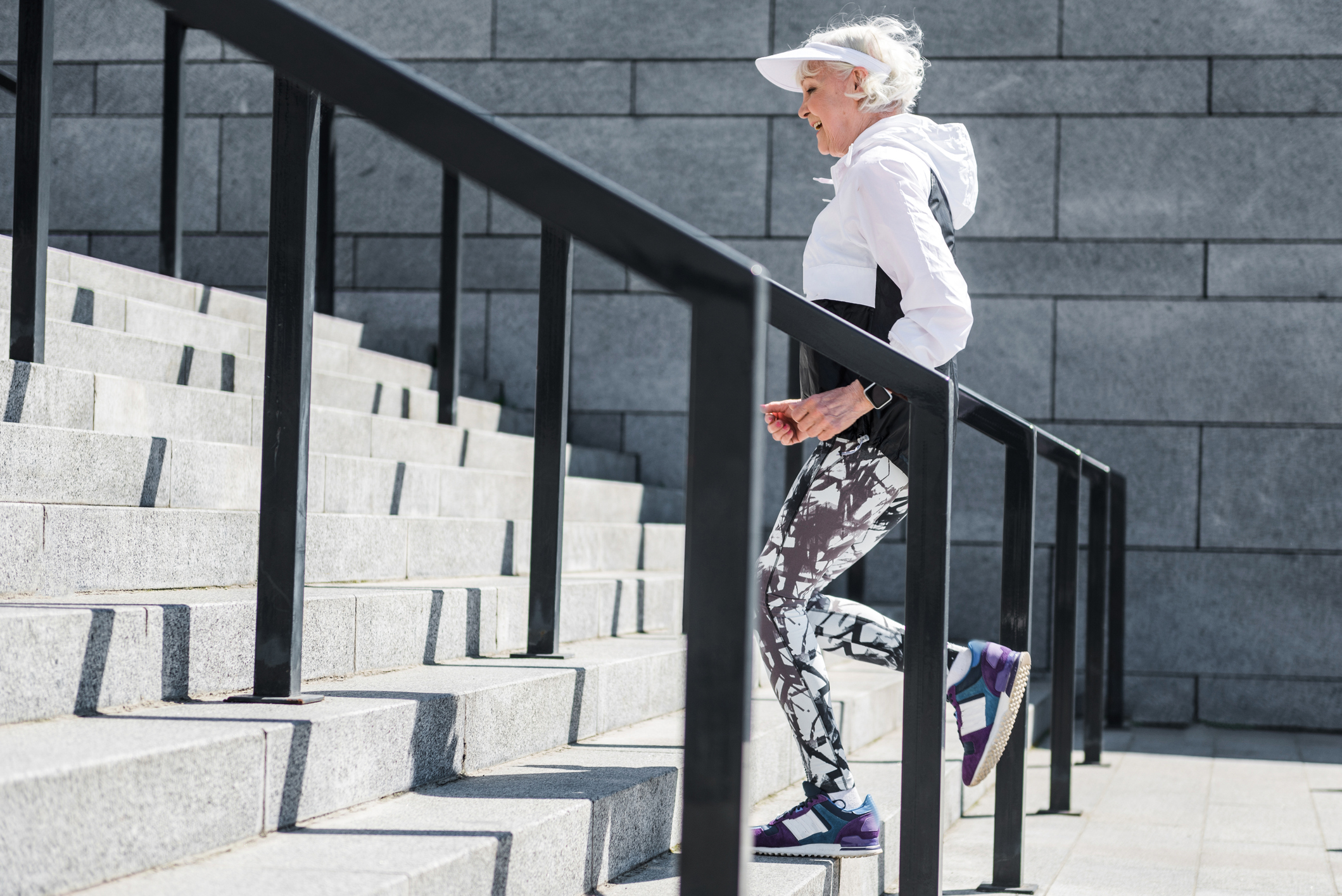 Cheerful-old-lady-training-to-run-up-concrete-stairs-696208932_2123x1417.jpeg