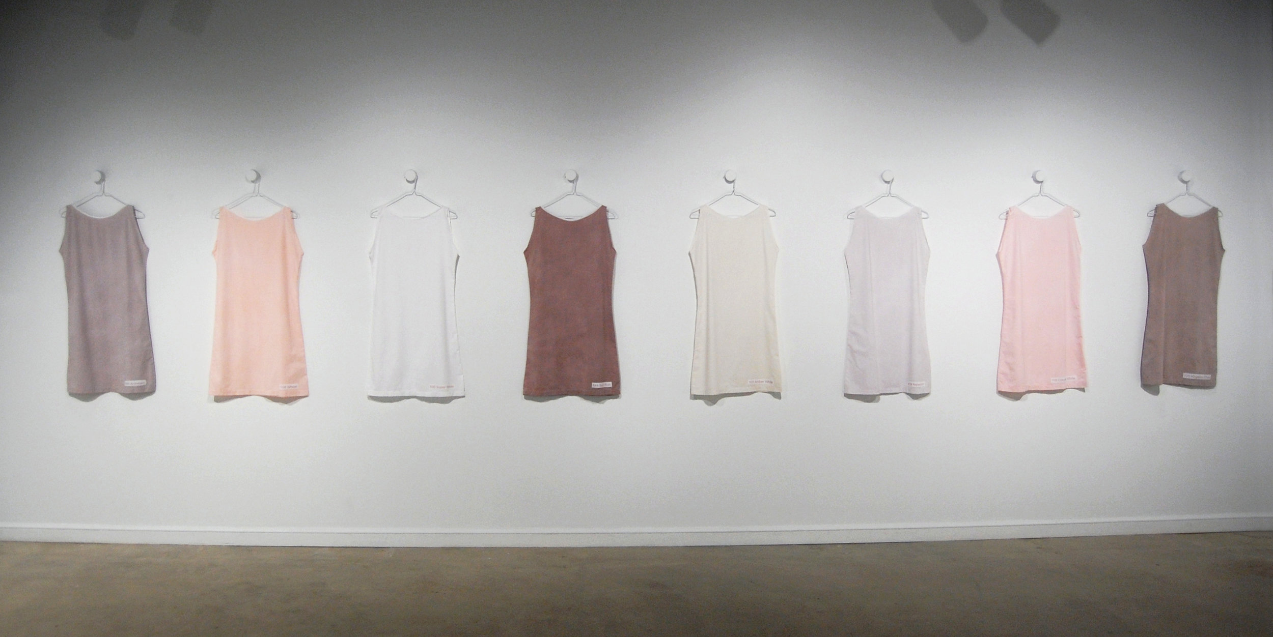  Figure 1:  Eight Exterior Color Choices for the CountrySide Subdivision  (installation view), dyed cotton, 19”x36” (individual dresses) 