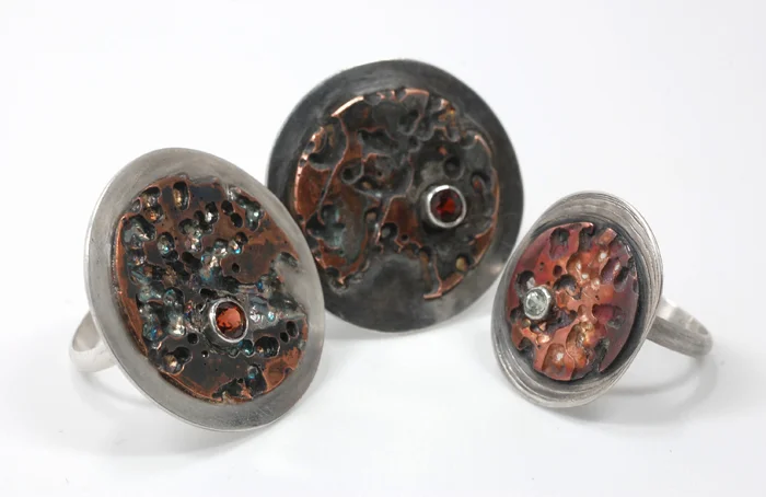 Landscapes rings, sterling silver, copper, garnets and peridot, ⅞" to 1" face, 2011