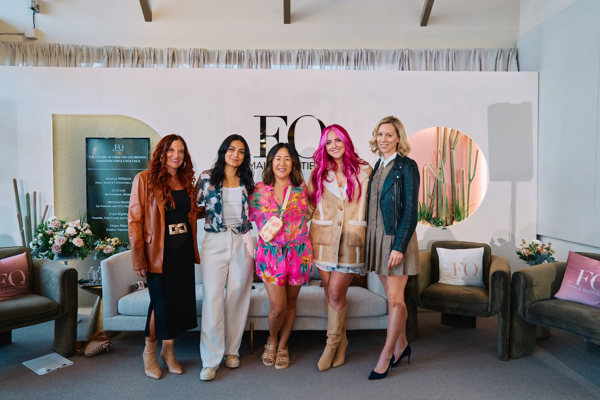 Group of five women standing together in a decorated room at an event, smiling for the photo, with a backdrop featuring a logo that reads 'FO Female Quotient'. during SXSW Event in Austin, TX