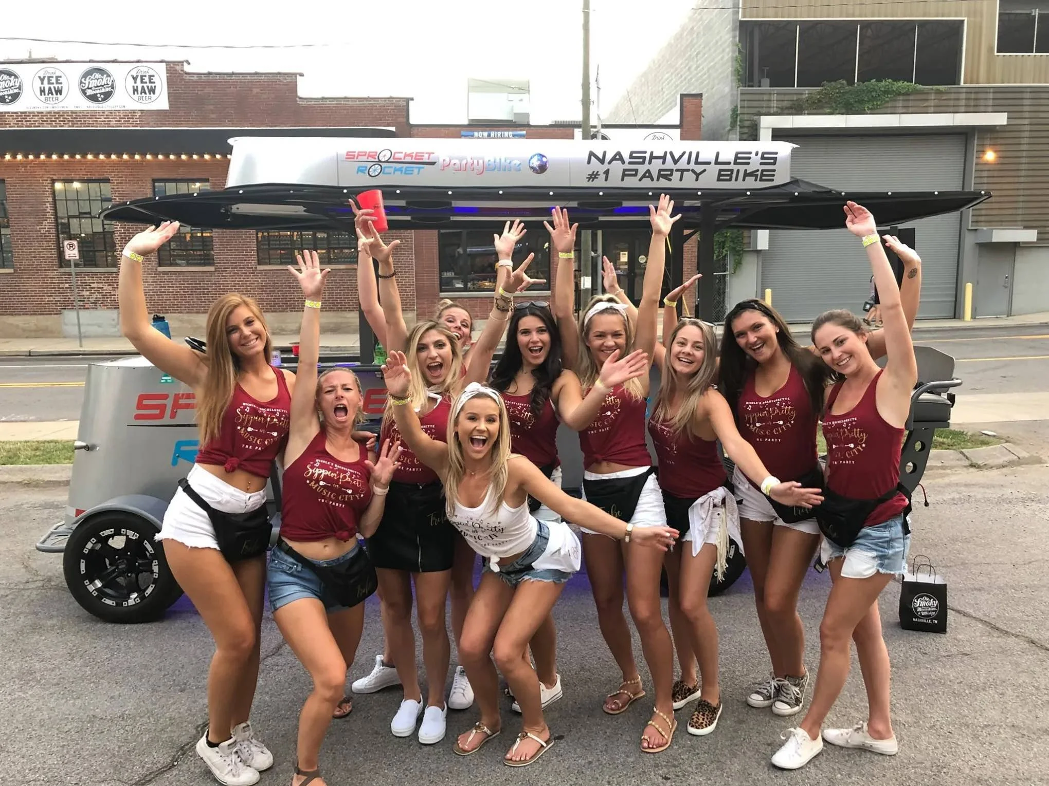 Nashville Bachelorette group posing in front of their Sprocket Rocket Party Bike