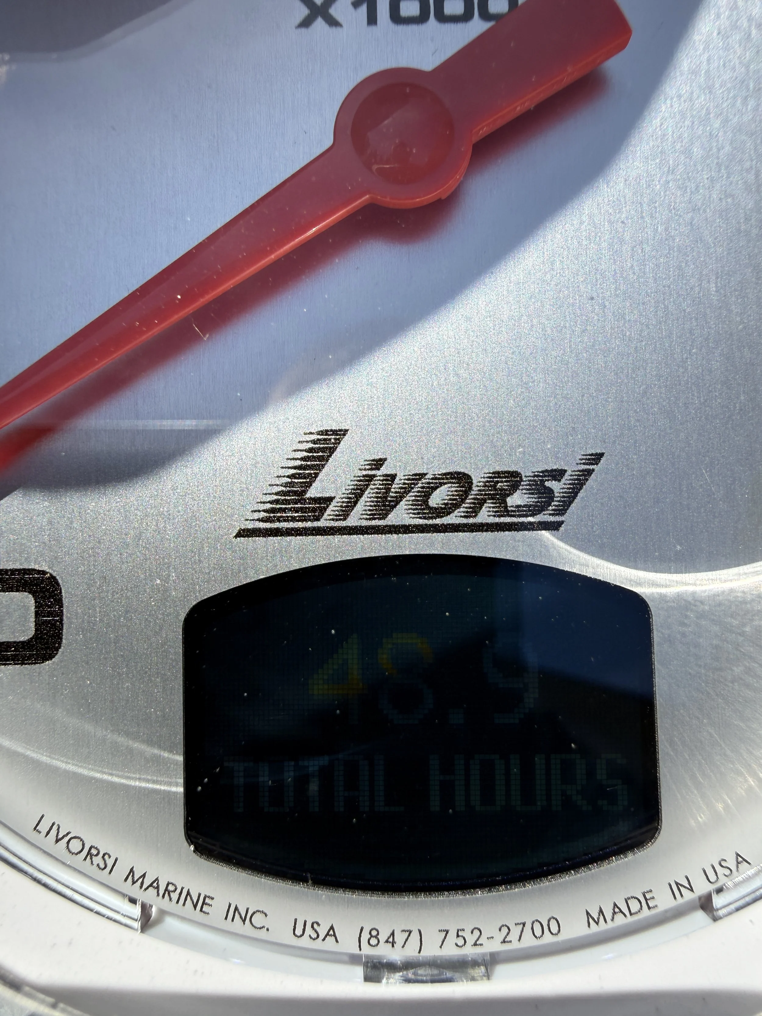 A red plastic measuring spoon on a digital kitchen scale. Has the brand name 'Livosri' visible.