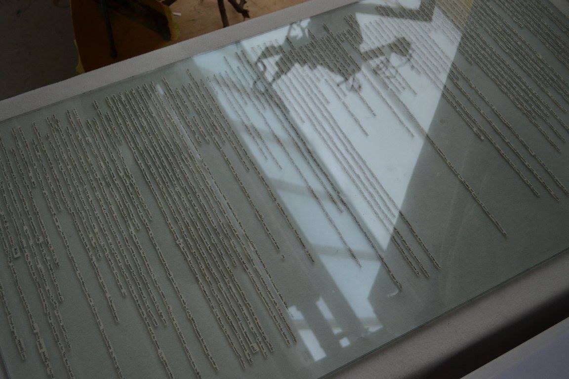 Lying on a white table sits an 800cm high slab of hardened glass. Sealed inside sits the entirety of the 1812 version of Grimm’s ‘Cinderella’. Hand placed and cut from a first edition of Sylvia Plath’s ‘Collected Poems’ the words act as a marker of Ted Hughes and Plath’s terminal marriage. The ‘Collected Poems’ (1981), edited by Hughes, stands as the ideal physical representation of this relationship. It is a posthumously produced text created by Hughes loyal publishing company, Faber & Faber, with several poems included edited and completed by Hughes himself despite the fact that by this point Hughes has remarried and Plath has been dead for 18 years. Many consider this another attempt to bank off the back of suicide.