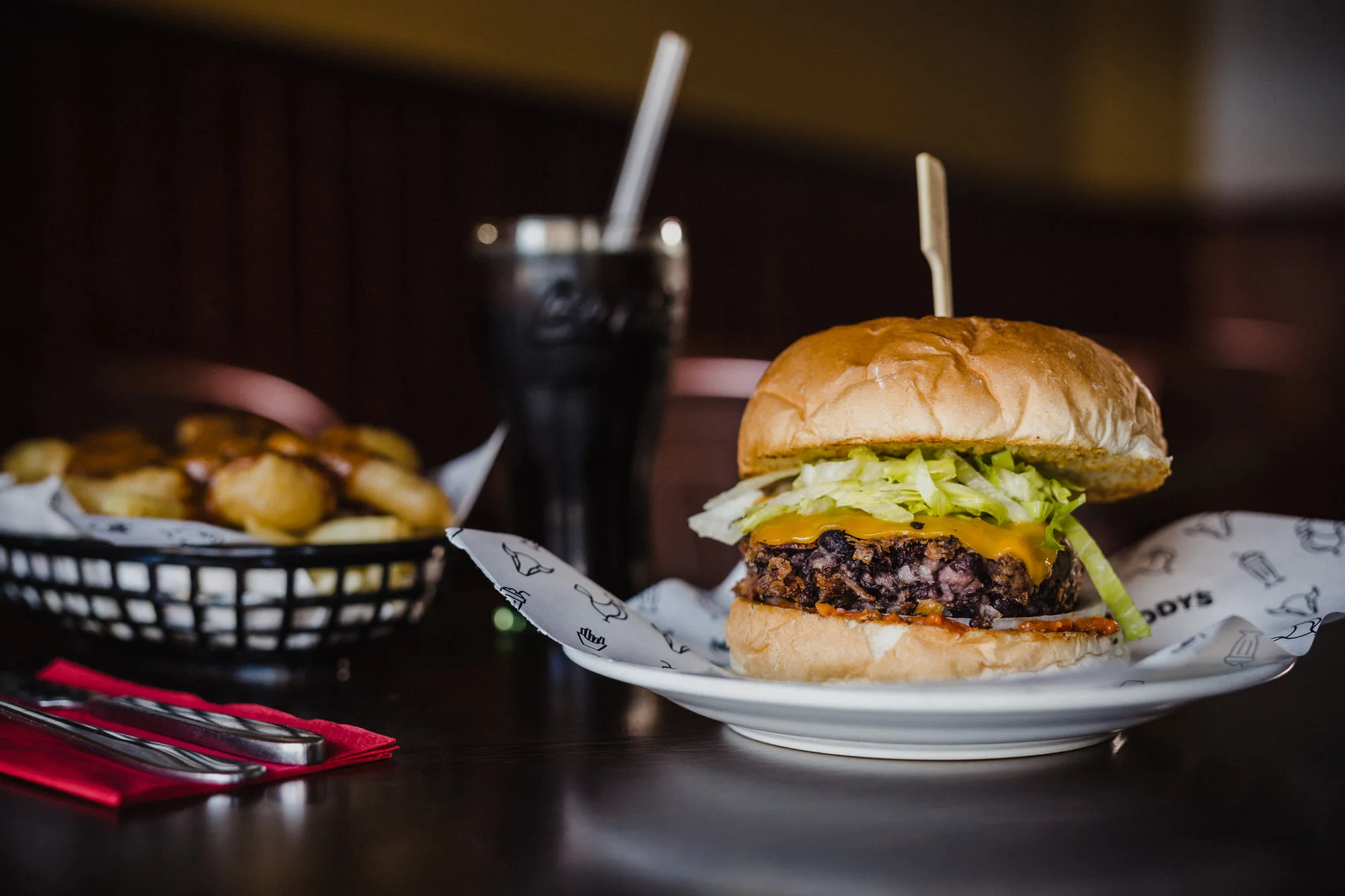 Black Bean Burger (Vegan): Black bean patty, vegan cheese, fiery tomato spread, red onion, jalapeños.