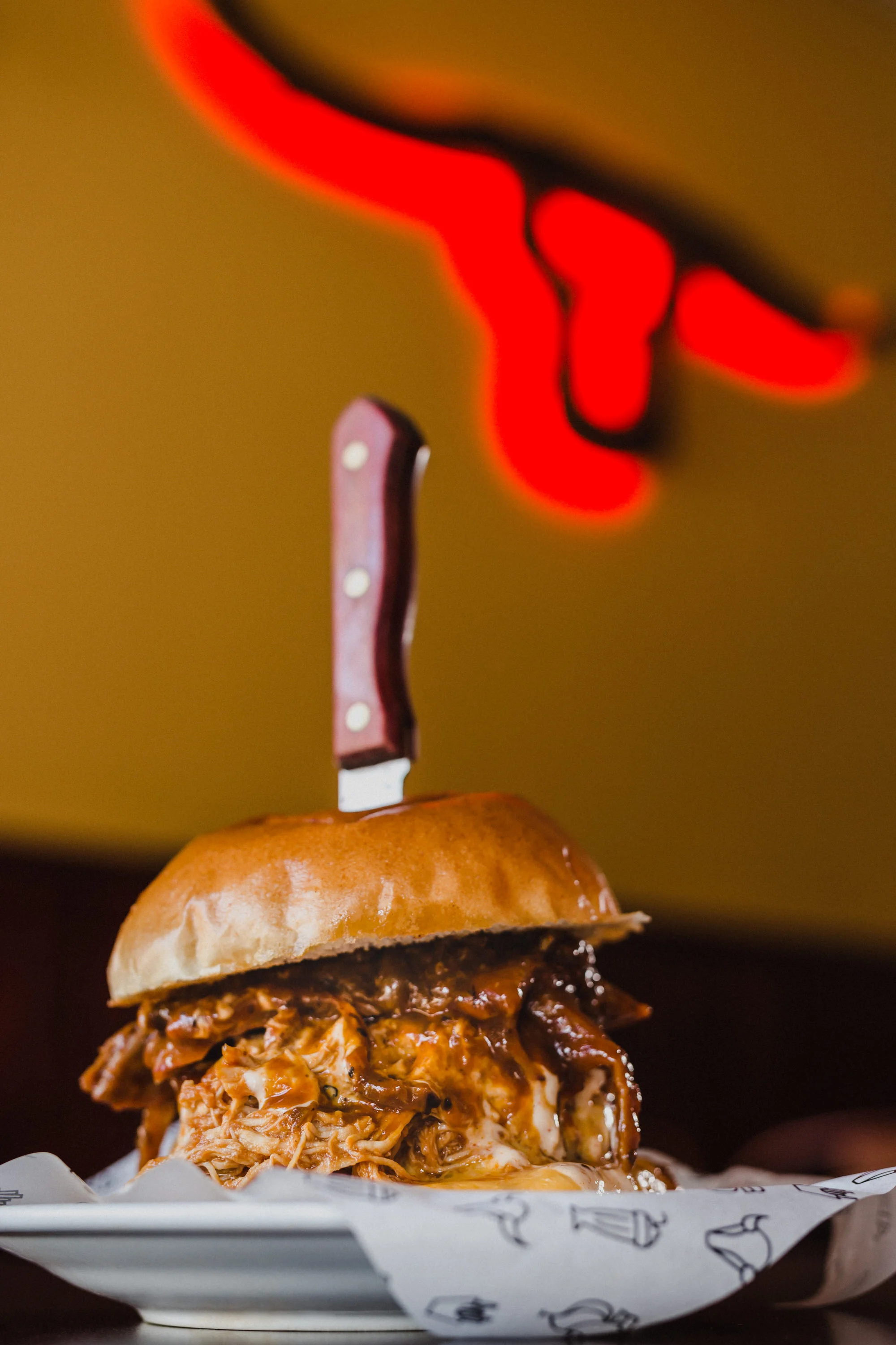 The Pit Burger: an epic double cheeseburger, topped with: 18-hour smoked brisket, pulled beef and pulled chicken, pit gravy and white BBQ sauce.