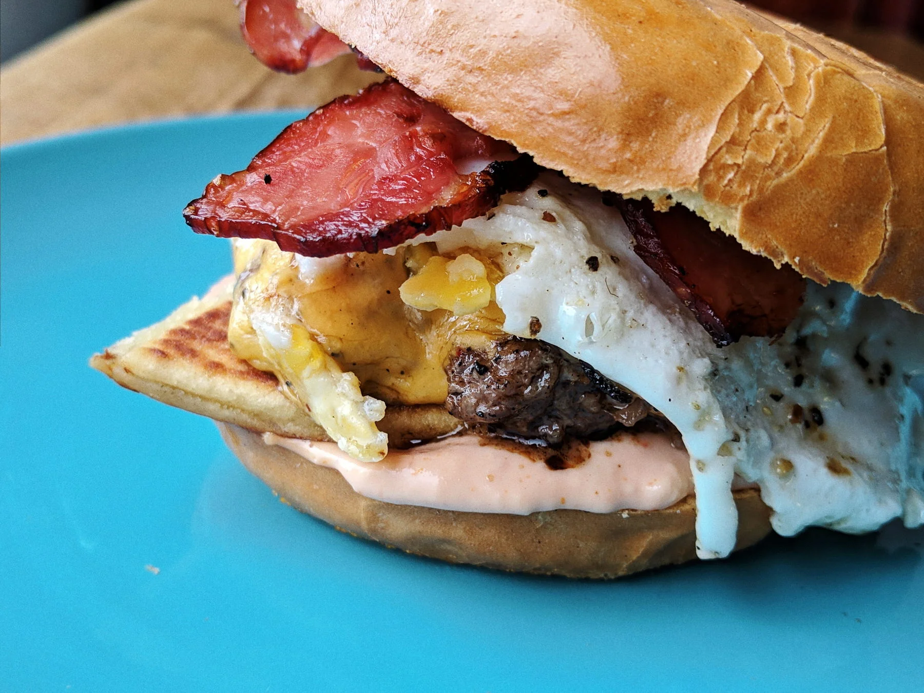 Our new Brunch Burger: cheeseburger, potato scone, fried egg and bacon on a bagel bun.