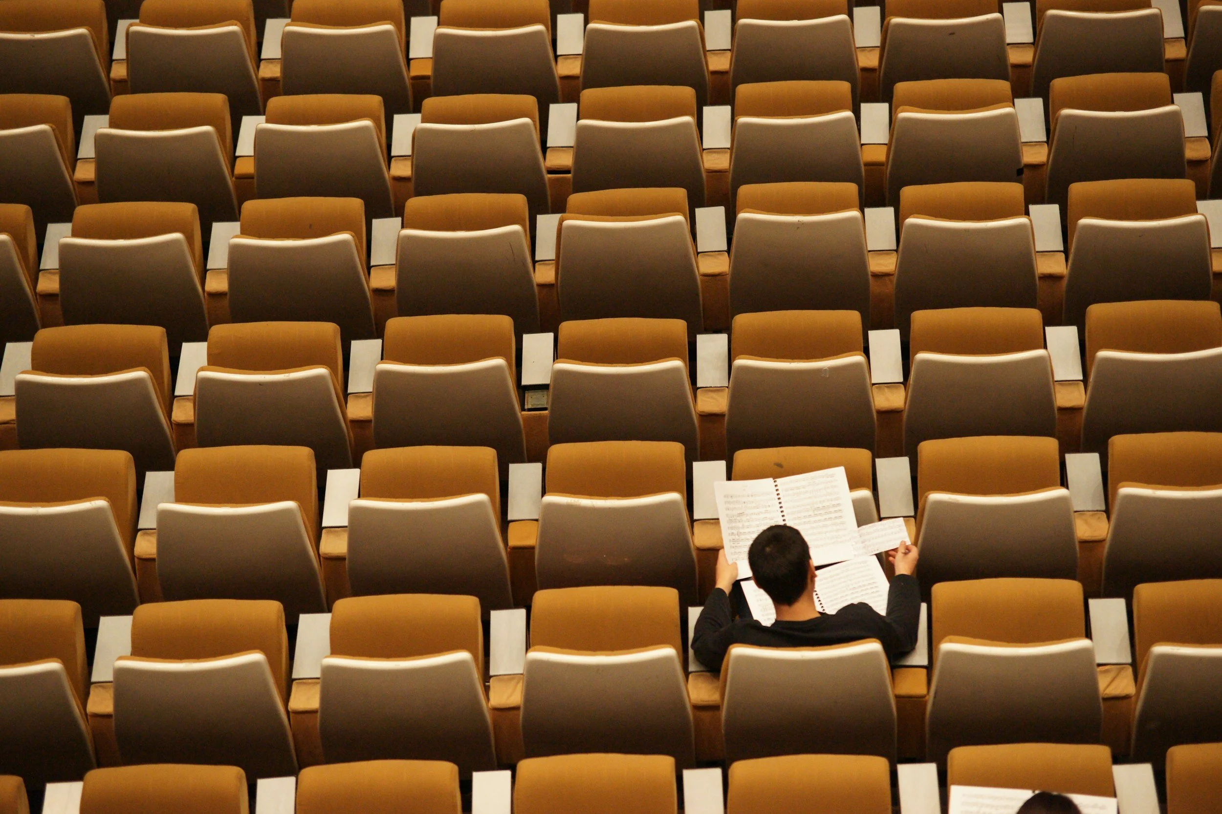 one person sitting in a lecture hall