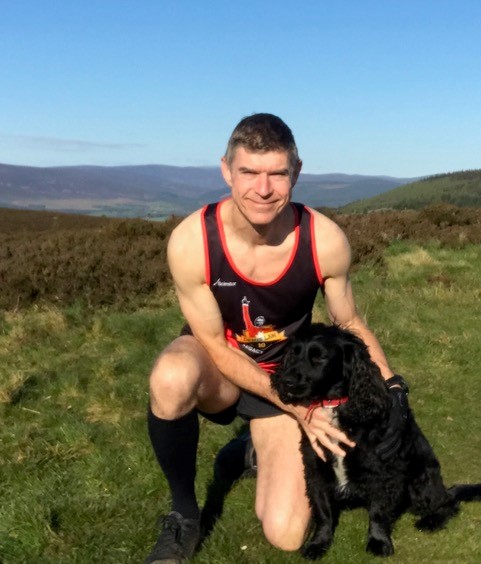 Dave training in his Denis Law Legacy Trust vest with his furry companion.