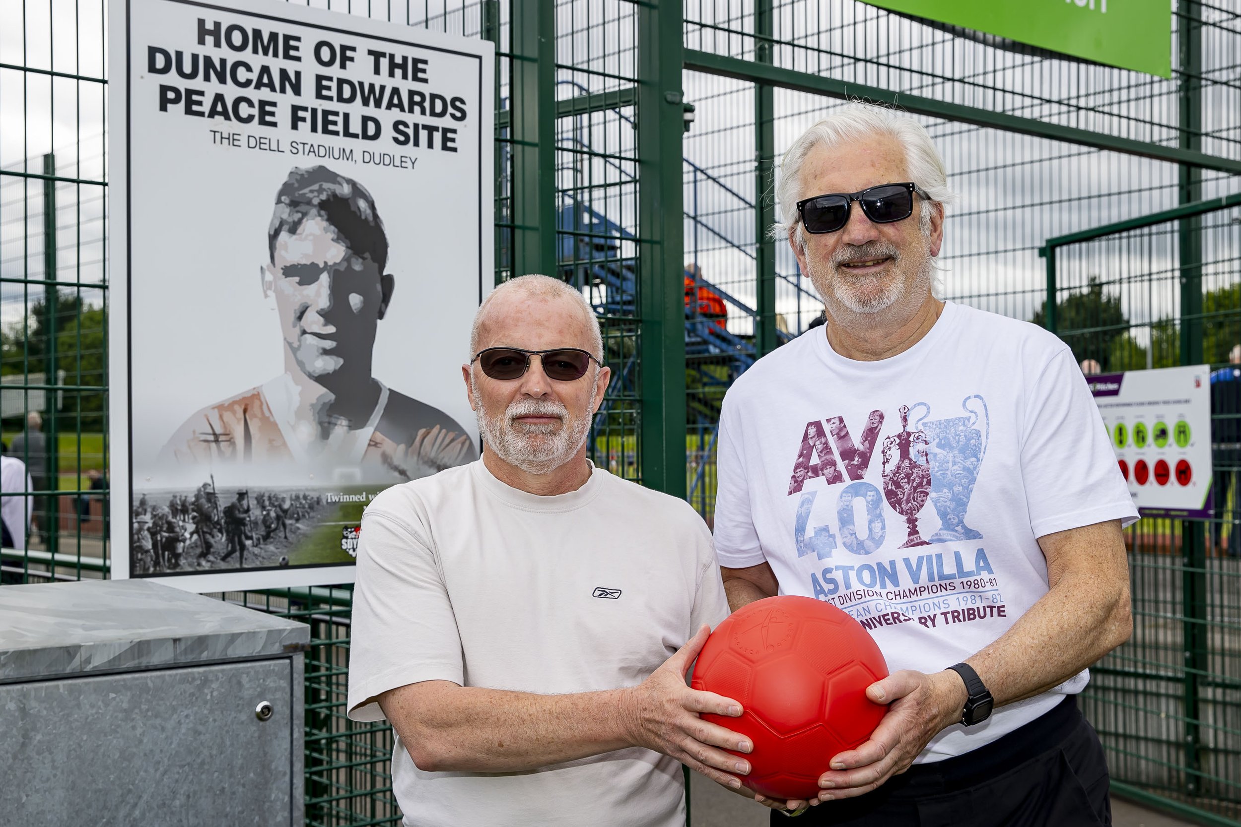 Dennis Mortimer with friend of the charity Steve and a Peace Field poppy football