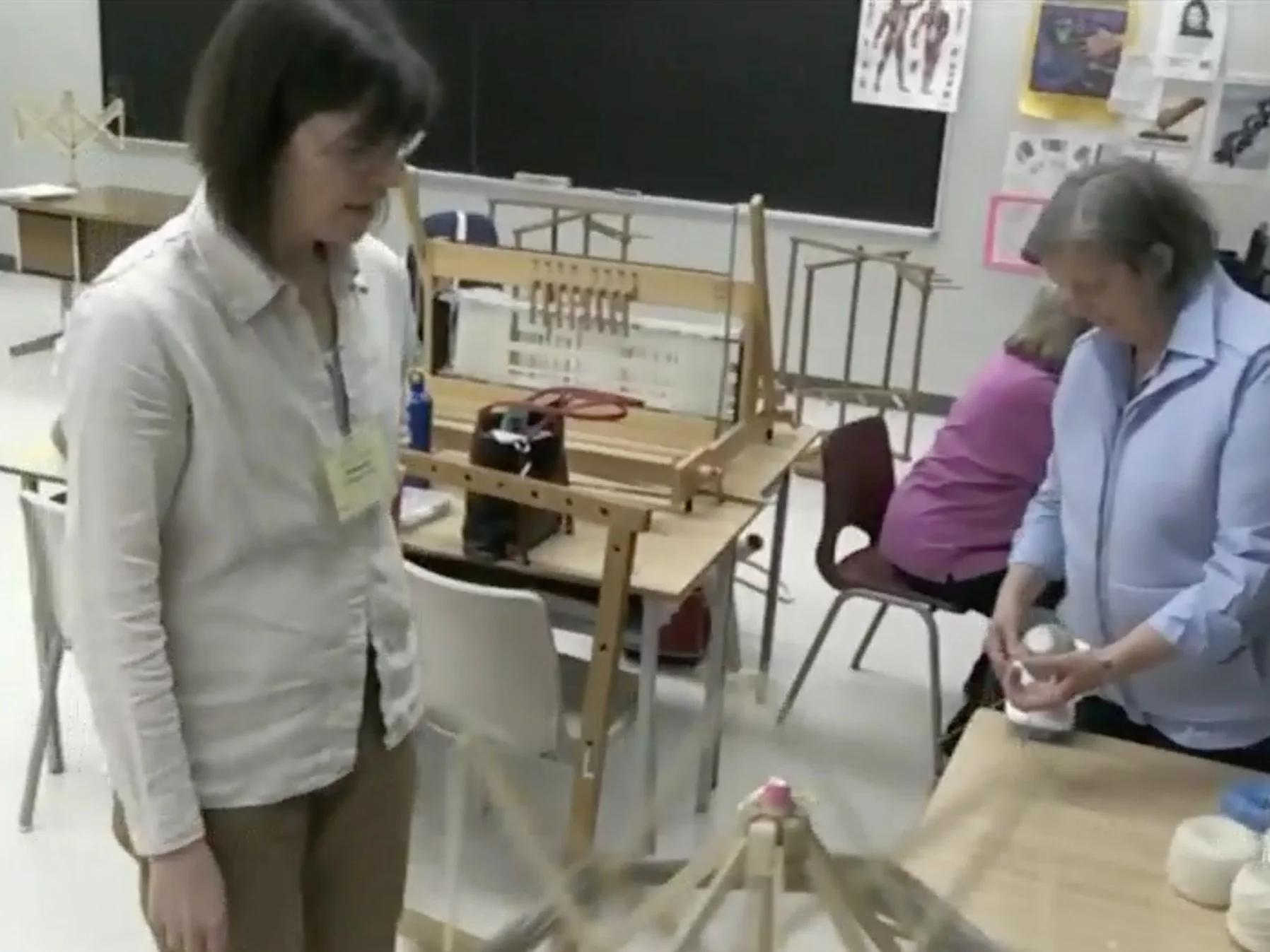 Deborah instructing a student in a weaving workshop.