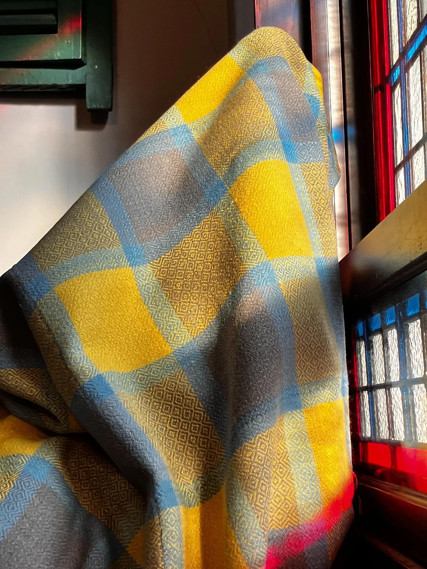 It&rsquo;s such a joy to see parallels between objects in the visual arts. In this case, a blanket and a stained glass window. 
When I took this goose eye blanket off the loom, I was struck with its similarity to a window in our house. The play of li