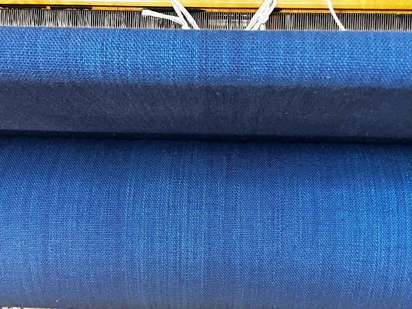So satisfying to see a cloth beam filled with Ontario plain weave wool fabric.
We sourced our wool yarn from @topsyfarms for this intensely blue fabric. @ironcauldron.ca did formidable work dyeing the yarn for 24 yards of fabric. The goal was to achi