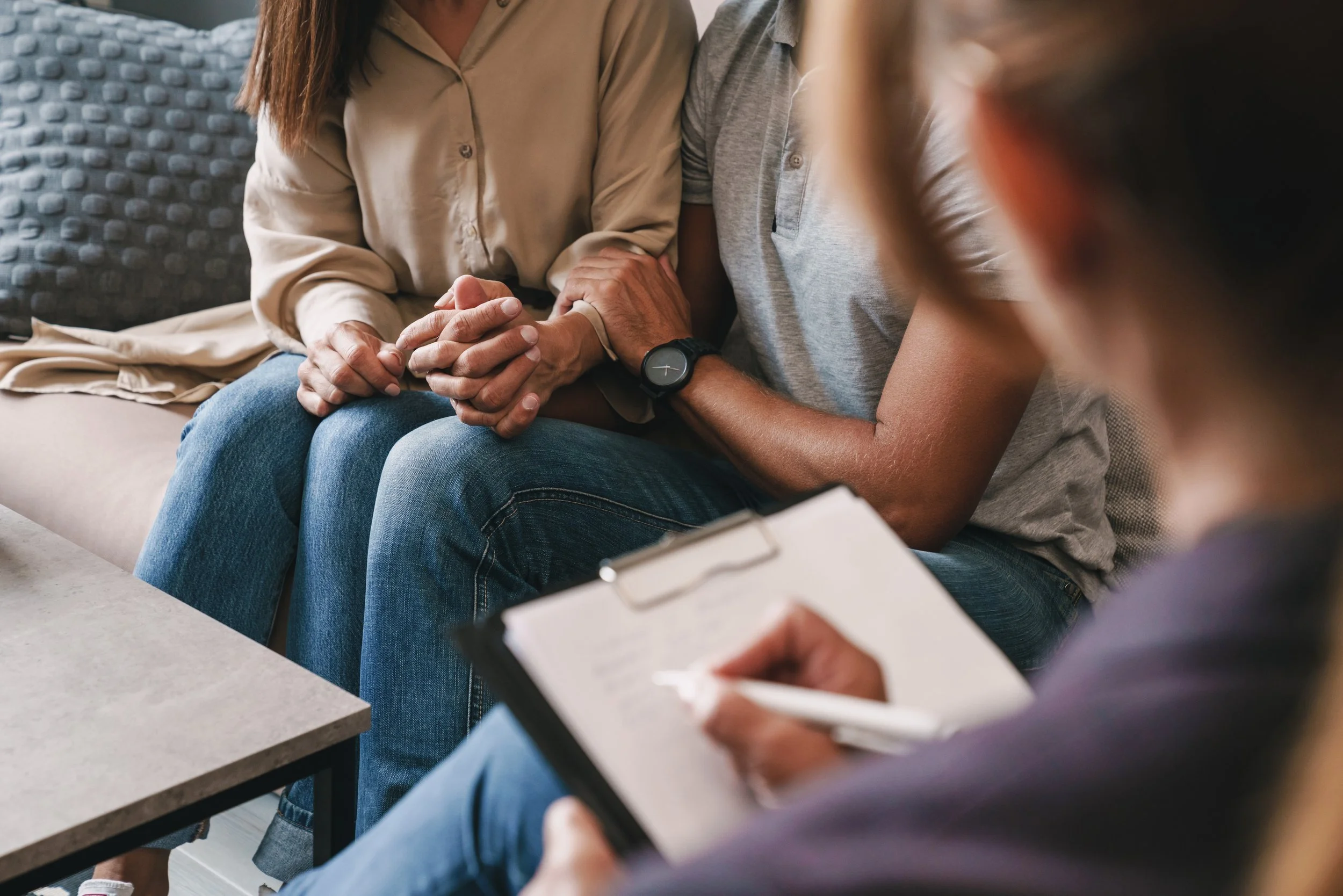 couple holding hands in therapy