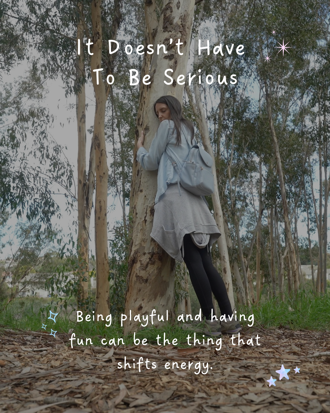 Woman playfully hugging a large eucalyptus tree in a grove, illustrating the lesson that Reiki practice doesn't have to be serious