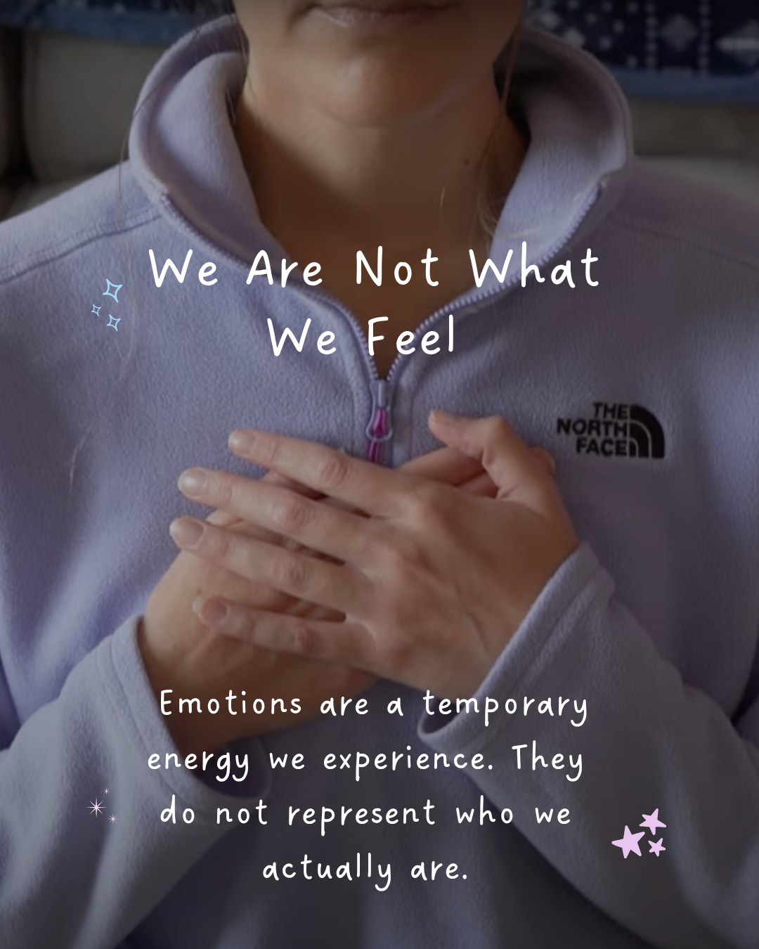 Close-up of hands clasped over the heart in a Reiki self-practice hand placement, illustrating the lesson that we are not what we feel
