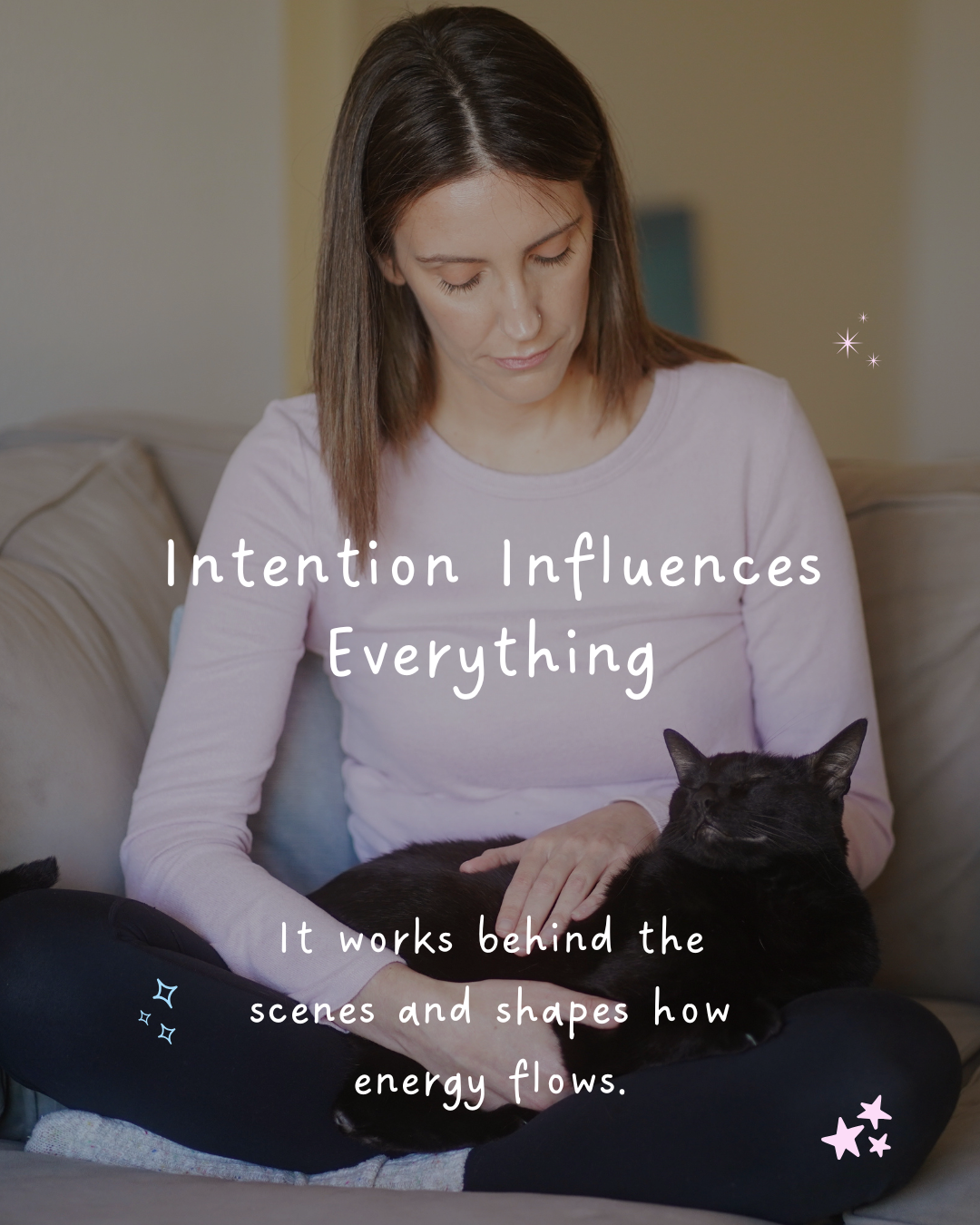 Woman sitting on a coach giving a black cat Reiki, illustrating the lesson that intention influences everything