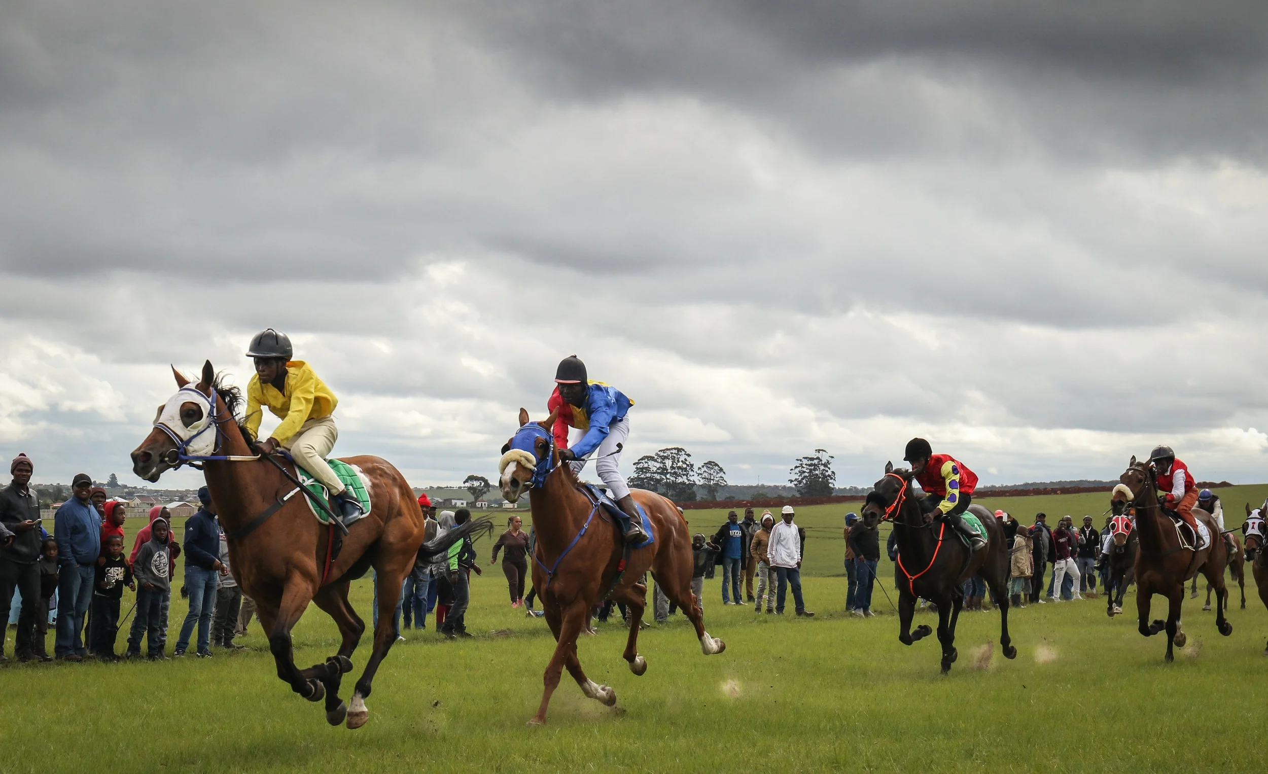 Young jockeys cross the finish line in a traditional horse race in South Africa’s Transkei region