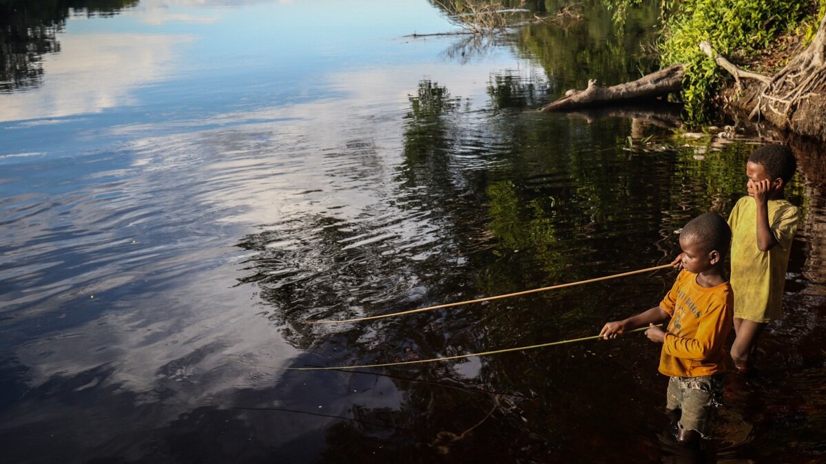   Young boys fish on the Lopori River in the DRC  