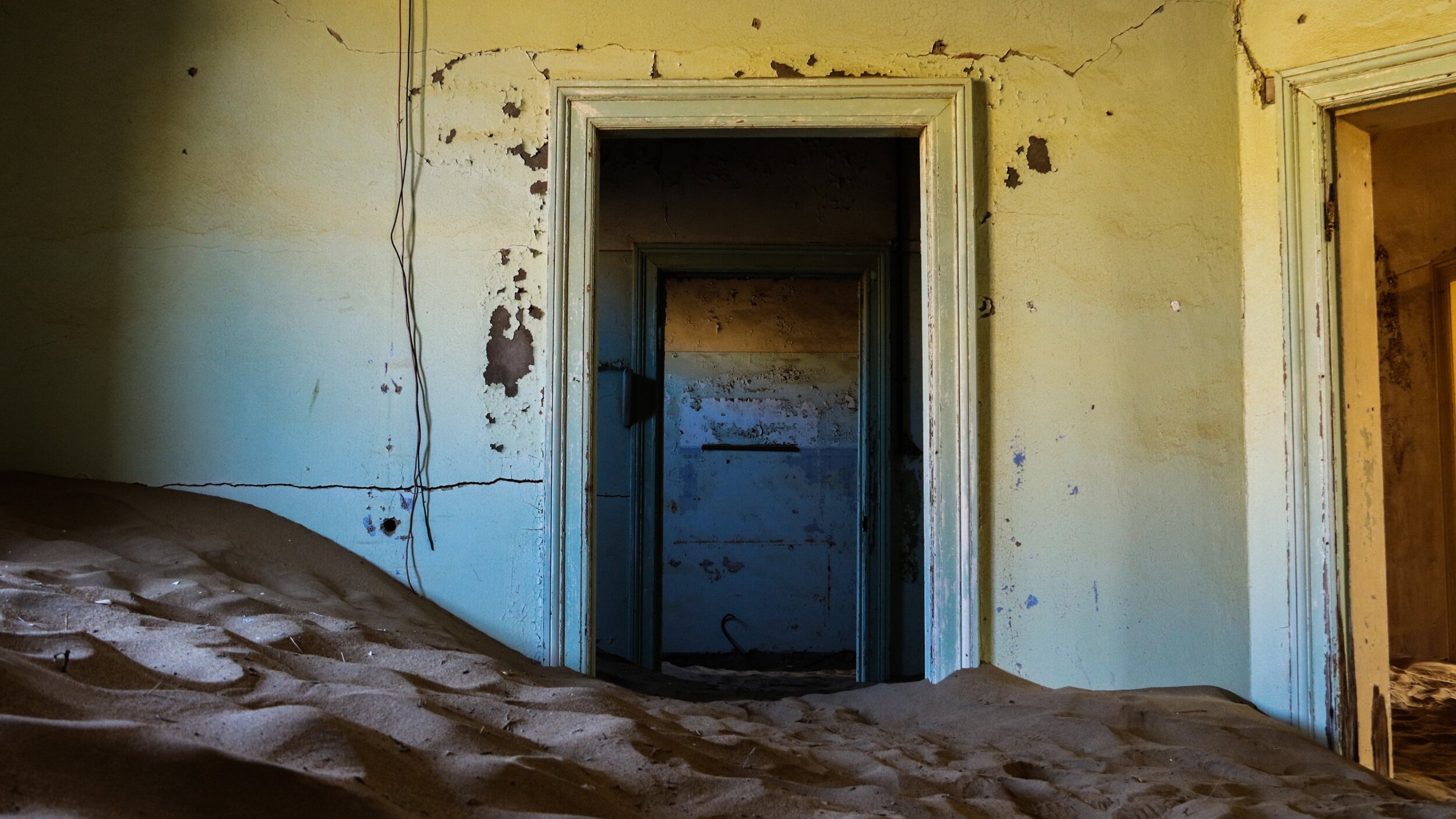   The desert gradually reclaims the abandoned mining town of Kolmanskop, Namibia  