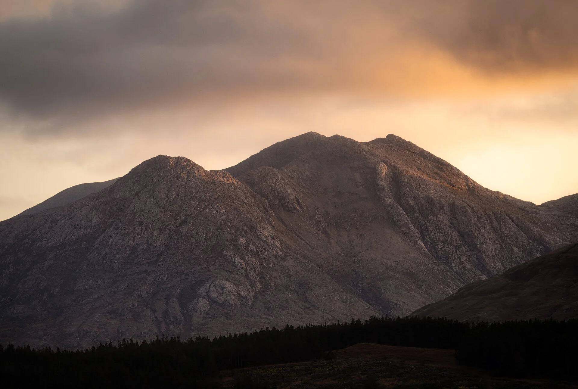 Golden light hitting the peaks of mountains in the west of Ireland. This was shot handheld at 100mm. Tack sharp! See below for the wide angle shot of this scene.