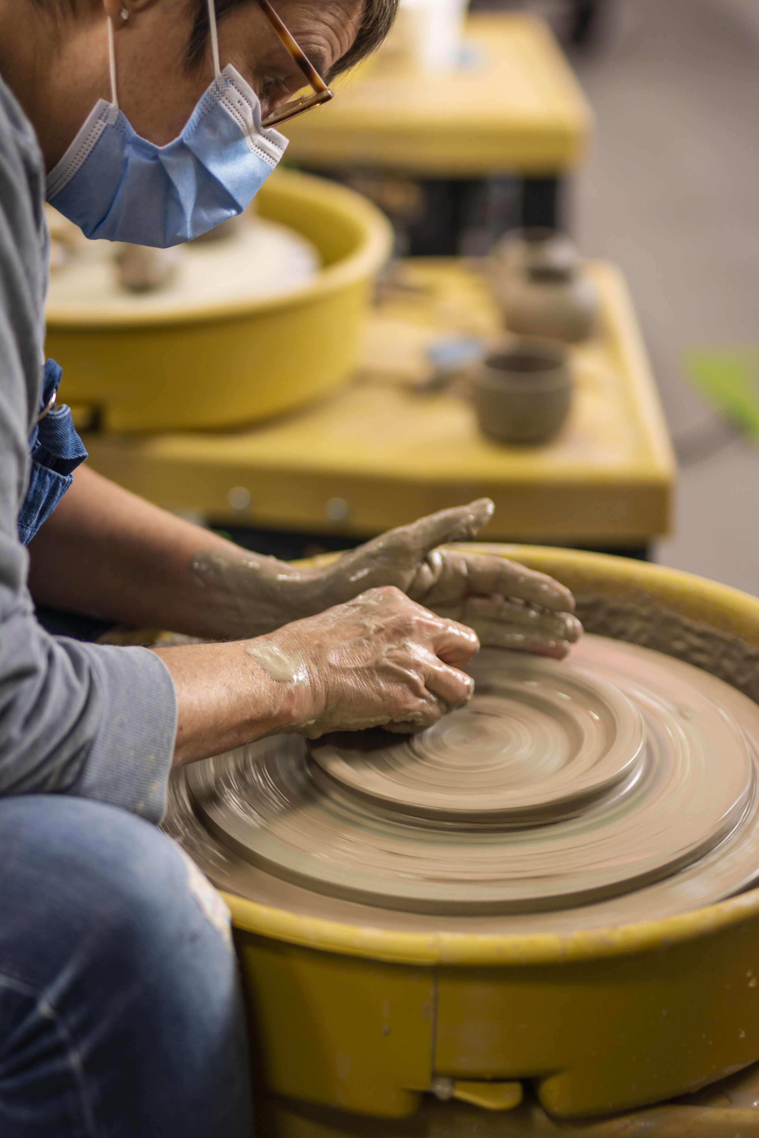  Norwich Pottery Studio learner throws a small side plate on the wheel during their beginners pottery course. 