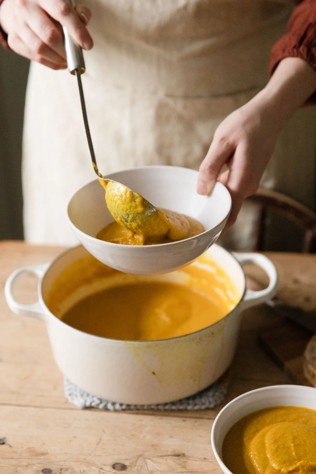 serving vegan soup in pot