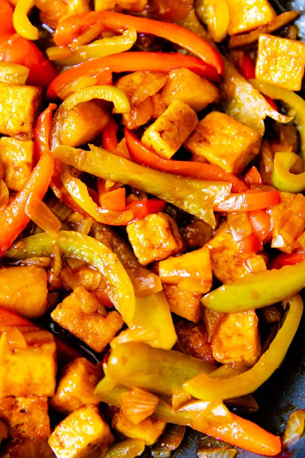 frying peppers and tofu in sweet and sour sauce
