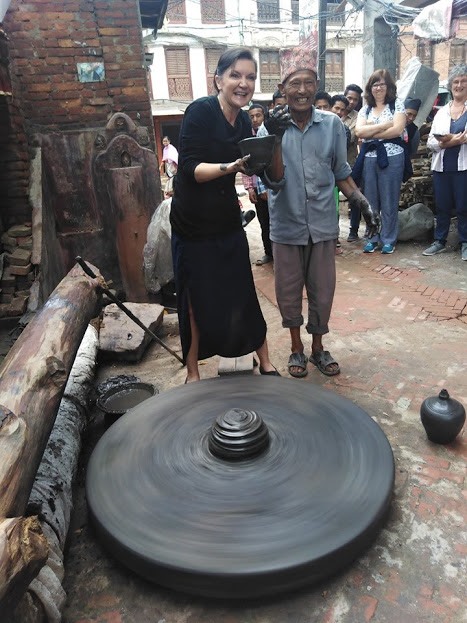 Our traveller getting hands on with the pottery wheel!