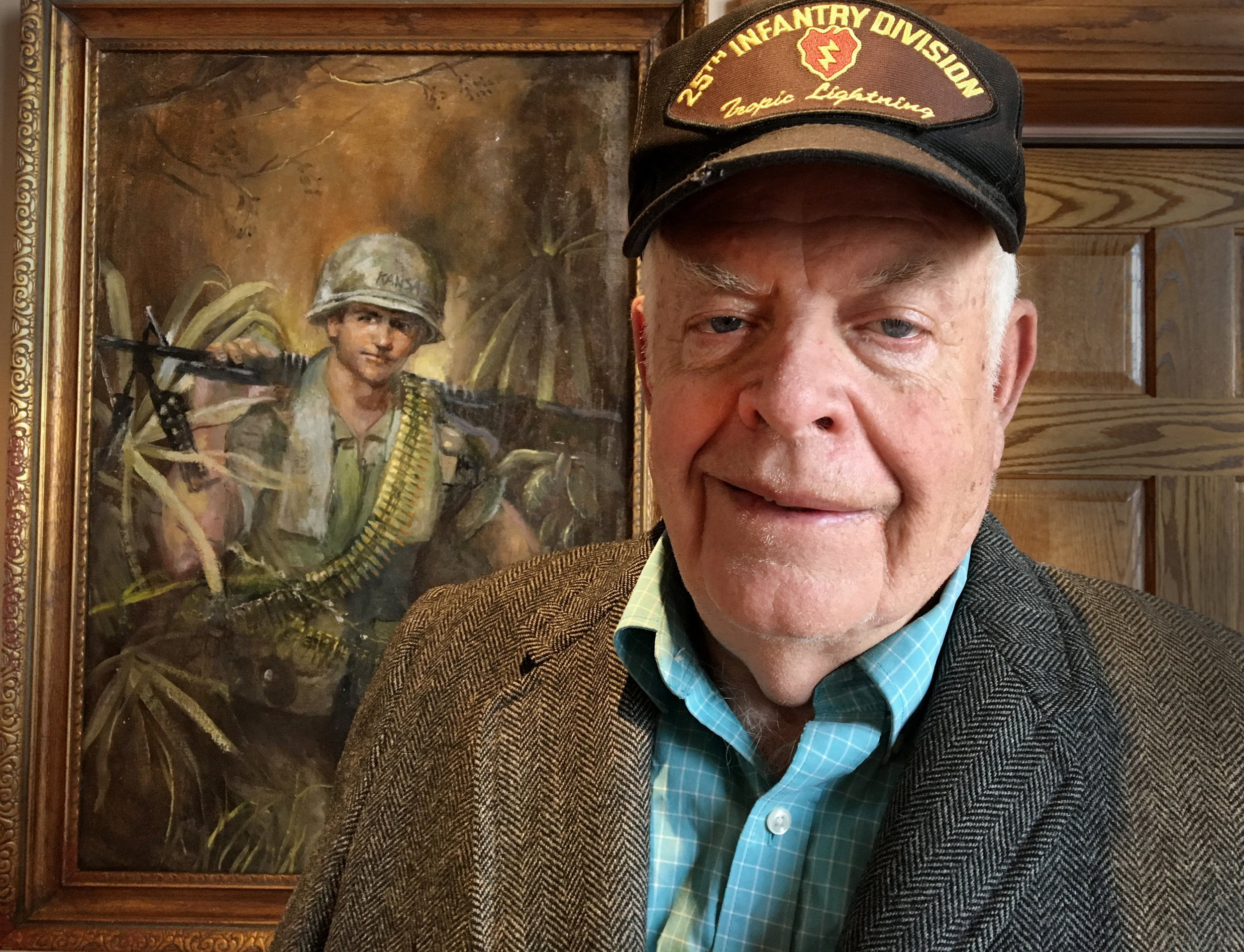 Jim Nelson with one of his original paintings, currently on display at Missouri’s National Veteran’s Memorial. Photo: Sean Loftin