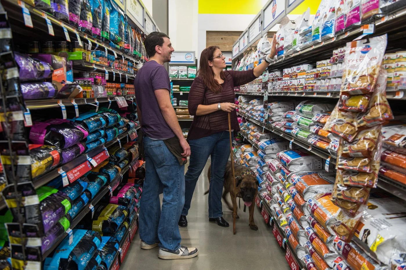An employee assists a customer with dog food at a Petco store in Clark, New Jersey.Photographer: Ron Antonelli/Bloomberg