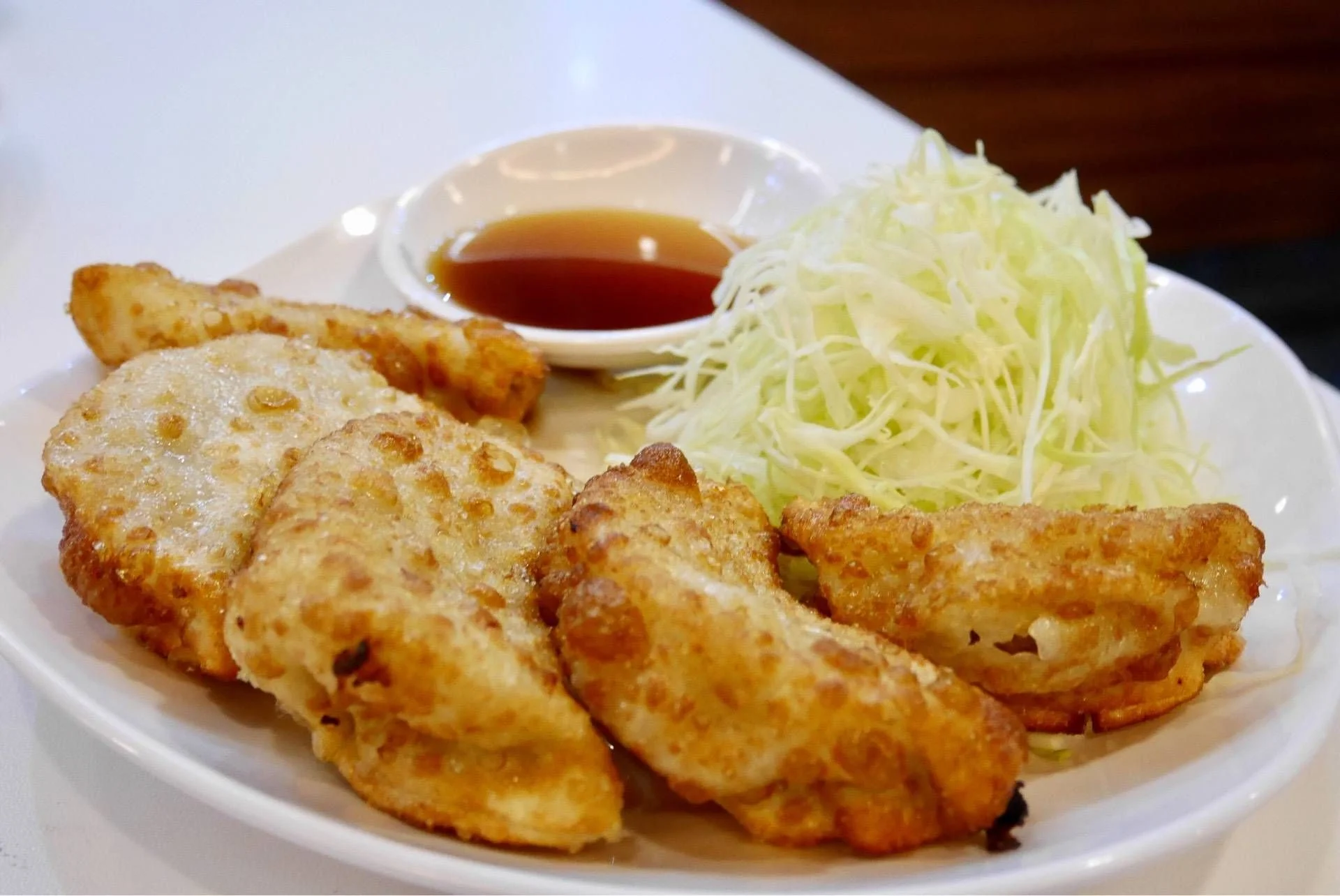 Pork Chicken Dumplings - 4 for $6 Ingredients: ground chicken and pork marinated in brown sauce with chopped cabbage and carrots. Served with dumpling sauce.
