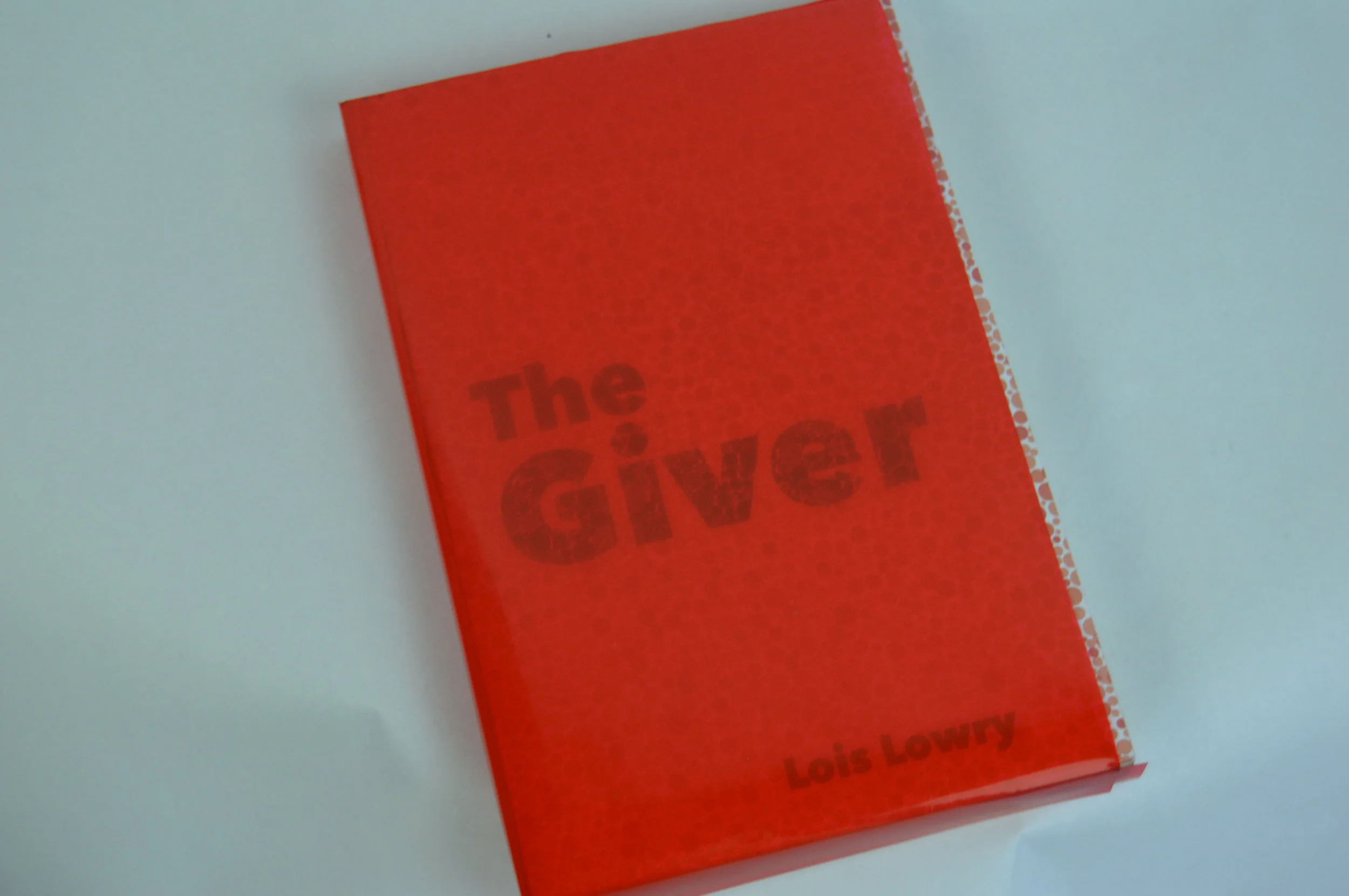  Close up with the jacket. As you can see, once the jacket is placed on the book, the dots seem to disappear. This is a play on how someone with color blindness may see things differently than others. 