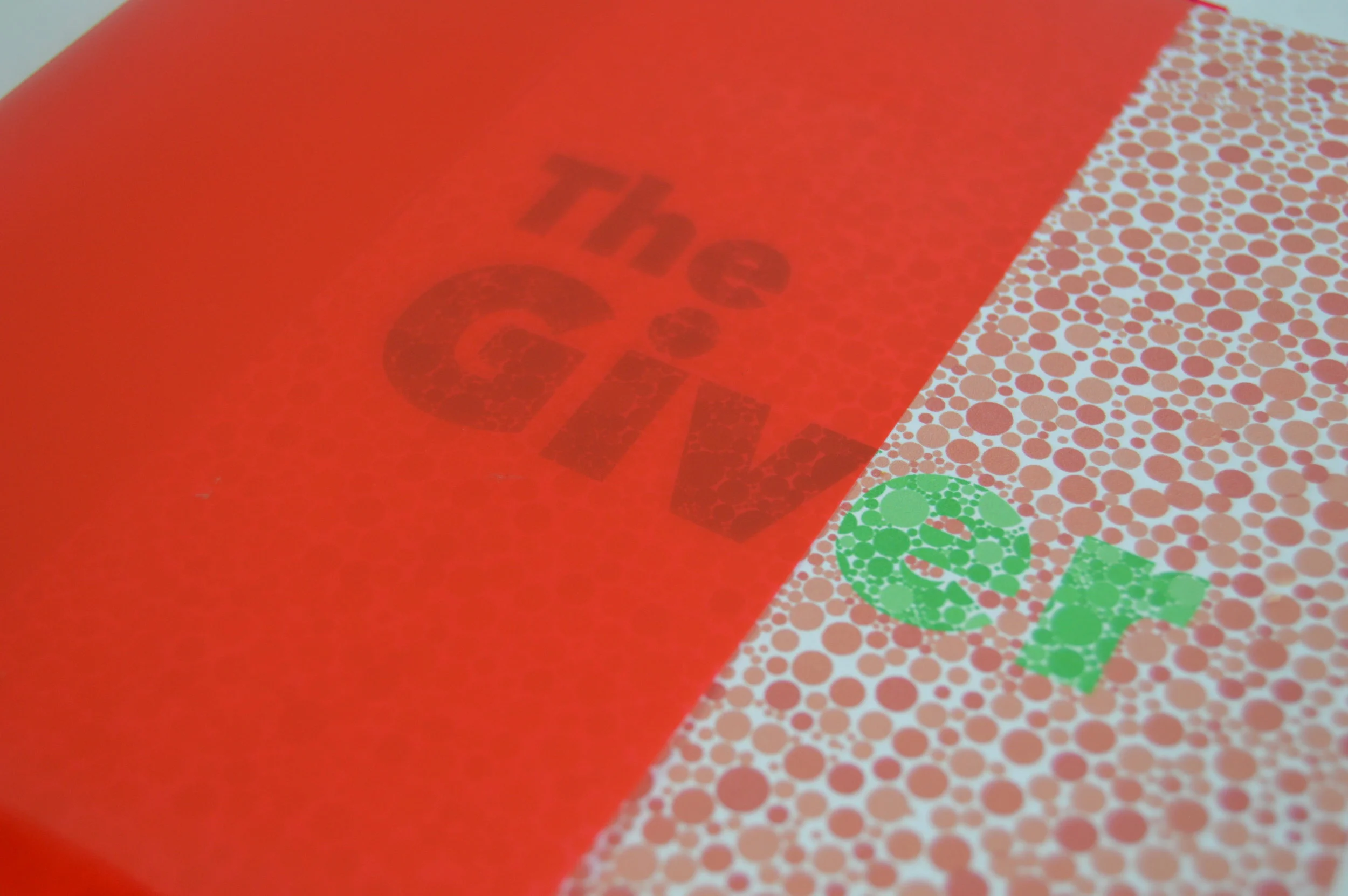  Additional close up of the cover with the jacket. You can see the contrast between the book with and without the jacket. Without the jacket the cover is complex and intricate, but with the jacket it is simplistic and minimal. 