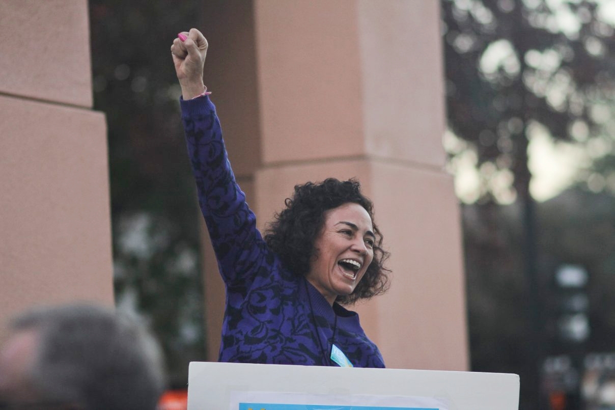 A member of Mountain View Tenants Coalition celebrating after winning rent stabilization in 2016.