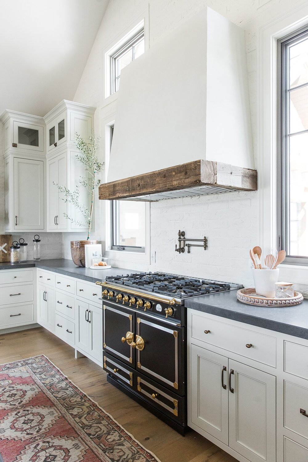 Refined,+rustic+kitchen+with+exposed+wooden+beams,+hanging+lanterns,+painted+white+brick,+oven+range+in+mountain+home+-+Studio+McGee+Design-3.jpeg