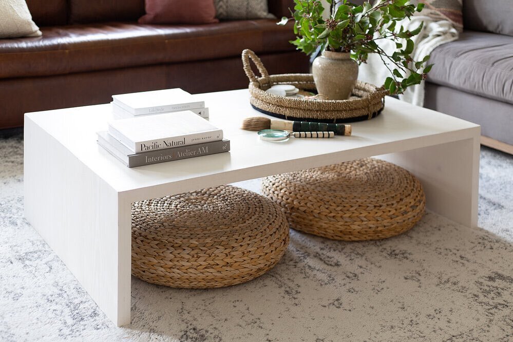 Coffee table styling with some great books, pretty objects, and a good tray to corral smaller items.