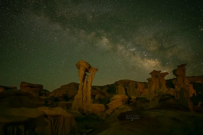 The rock formation called Alien Throne gently lit in for foreground with the Milky Way prominently lit in the background.
