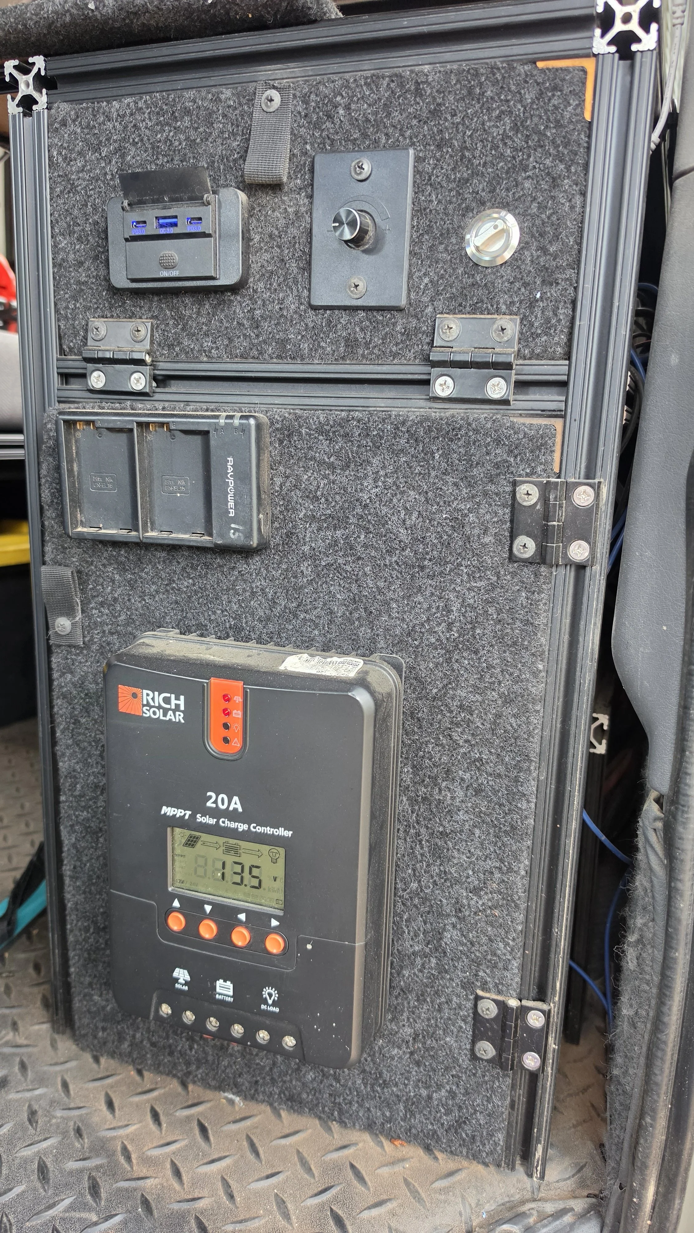 USB power panel and solar charge controller in the Mitsubishi Delica L300 house-power system used to power the OPENROAD awning lights.