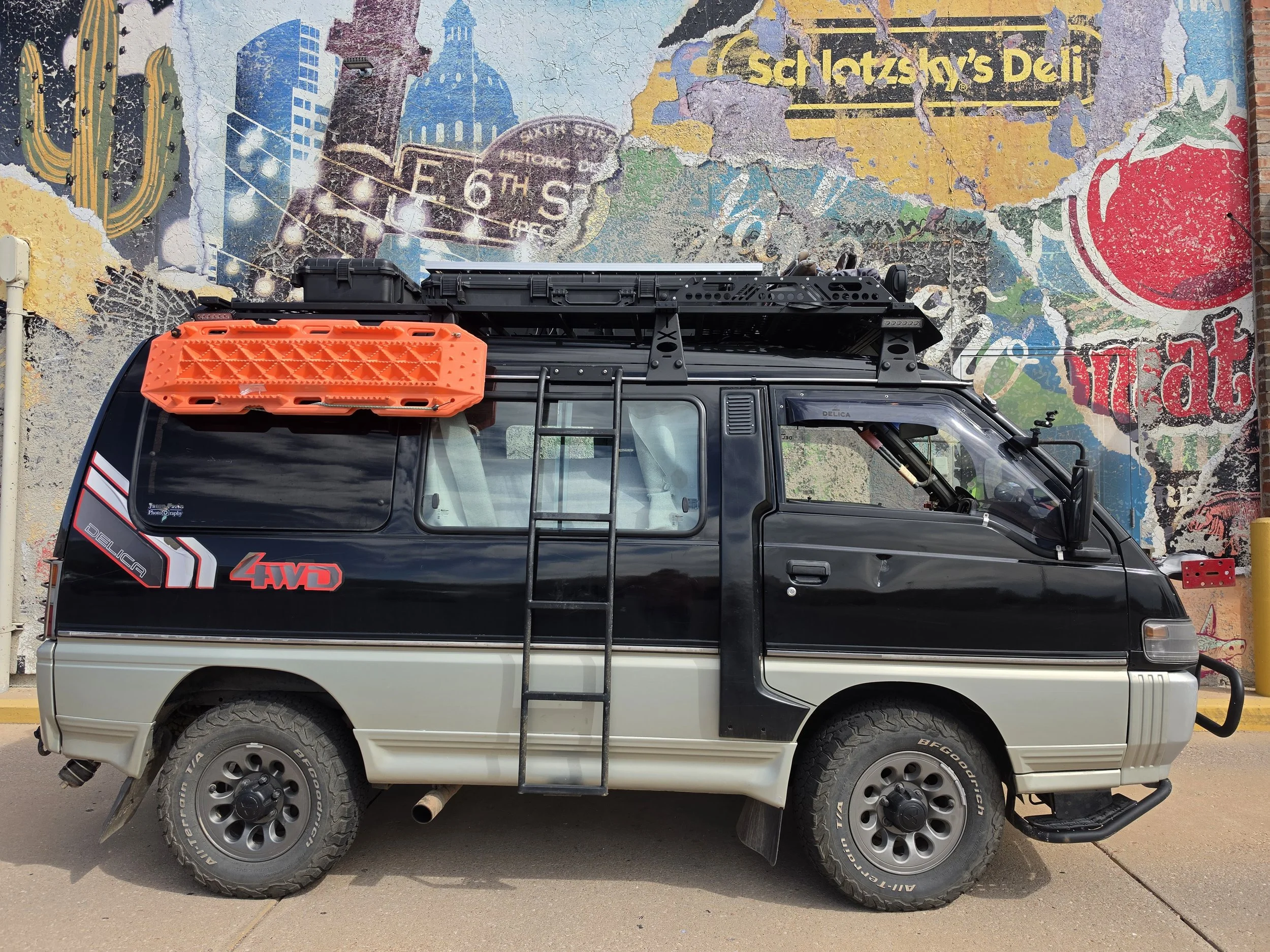 Driver’s side of a Mitsubishi Delica L300 showing the exterior ladder that currently prevents installation of sliding-window louvers.