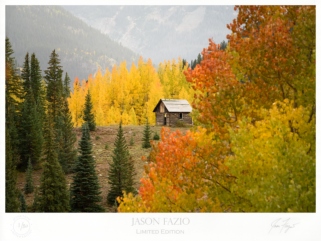 Cabin surrounded by Autumn colored trees