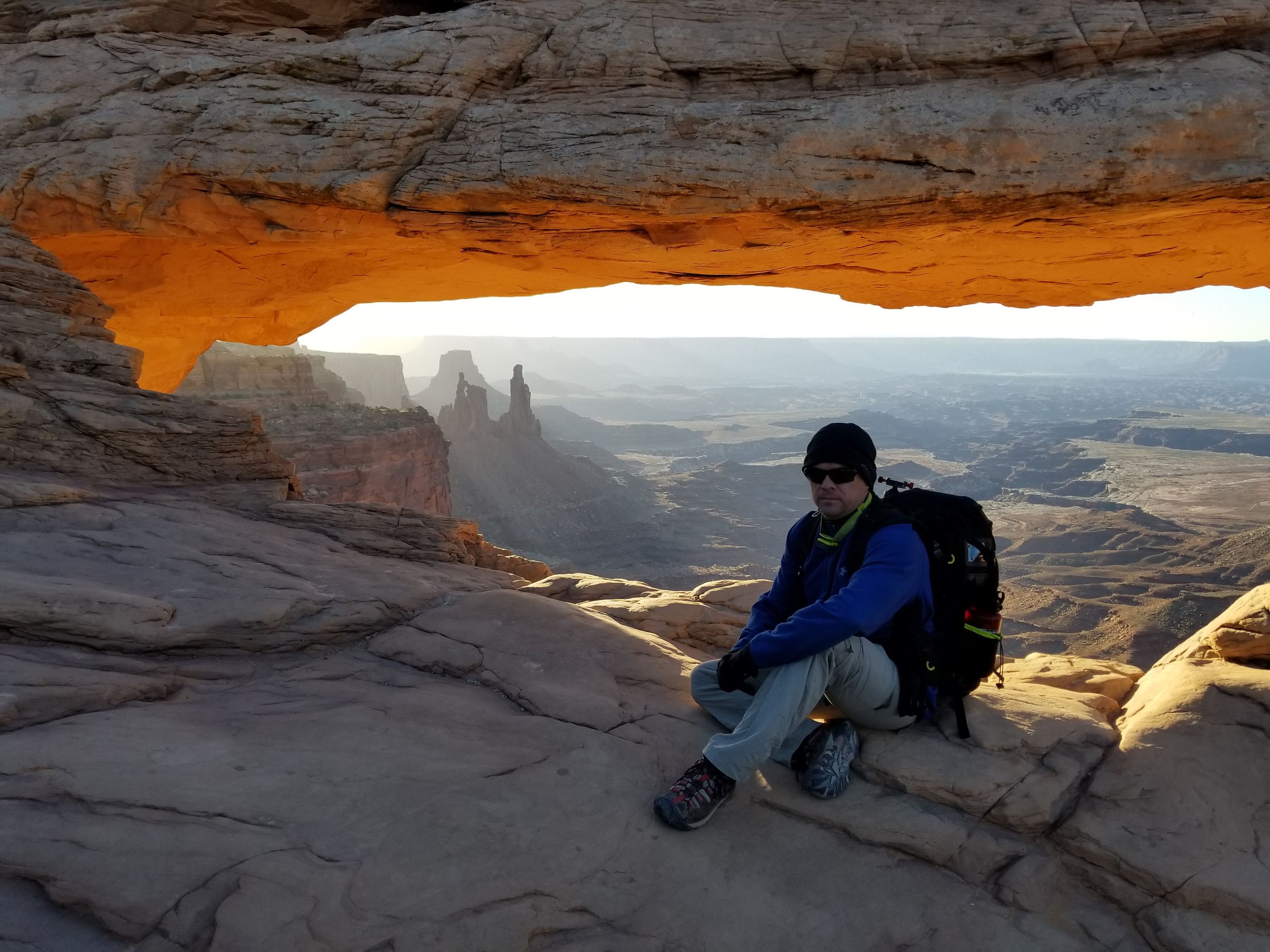 Landscape photographer Jason Fazio with camera gear in the Utah desert.