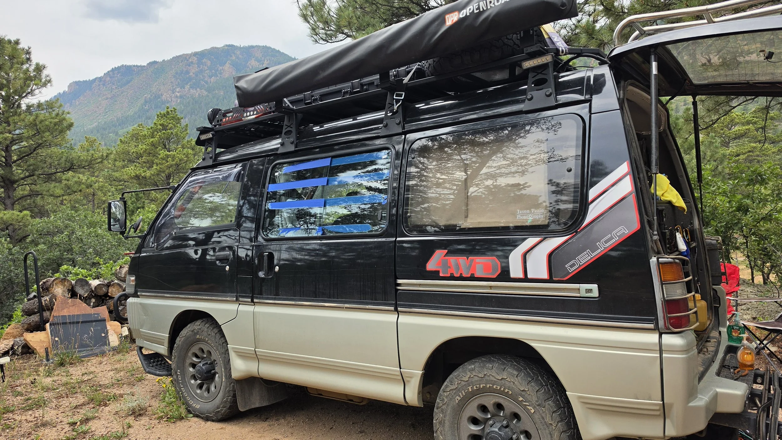 Sliding windows installed on the Mitsubishi Delica L300, aka the Five Billion Star Hotel, showing them on the correct side and with tape on them.