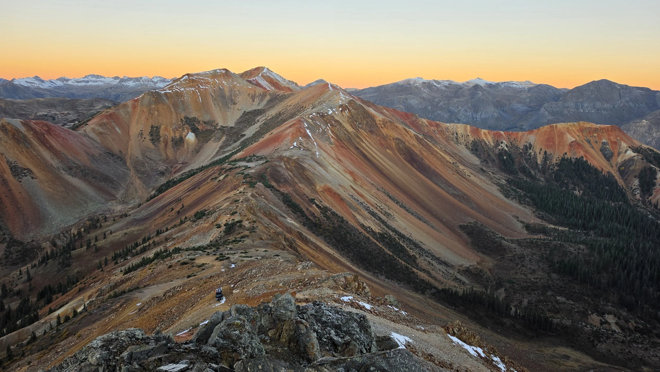 Mitsubishi Delica parked high on Corkscrew Pass beneath the colorful San Juan Mountains near Silverton, Colorado.
