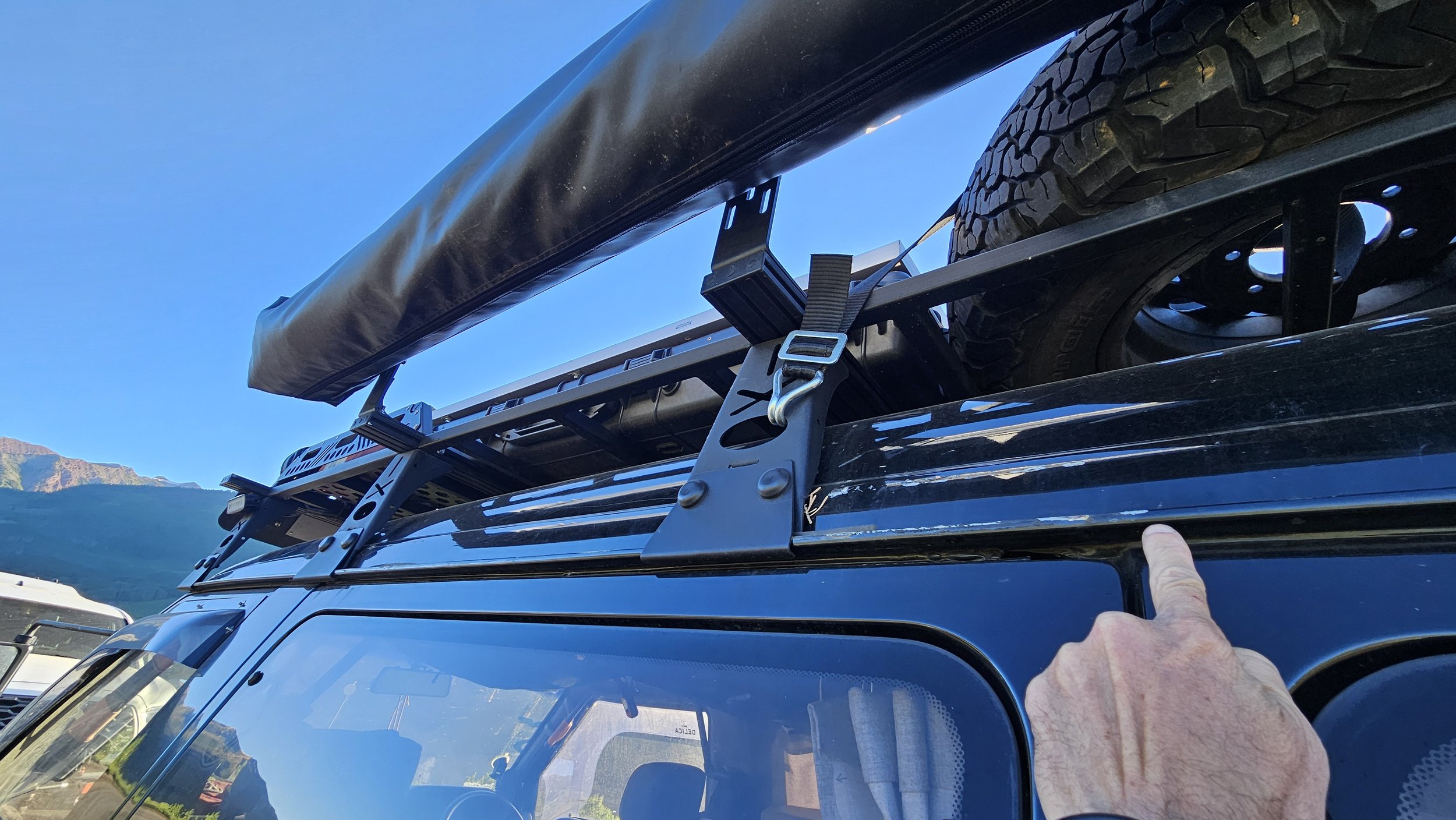 OPENROAD Adventure Series 270-degree awning mounted high on the passenger side of a Mitsubishi Delica L300 roof rack.