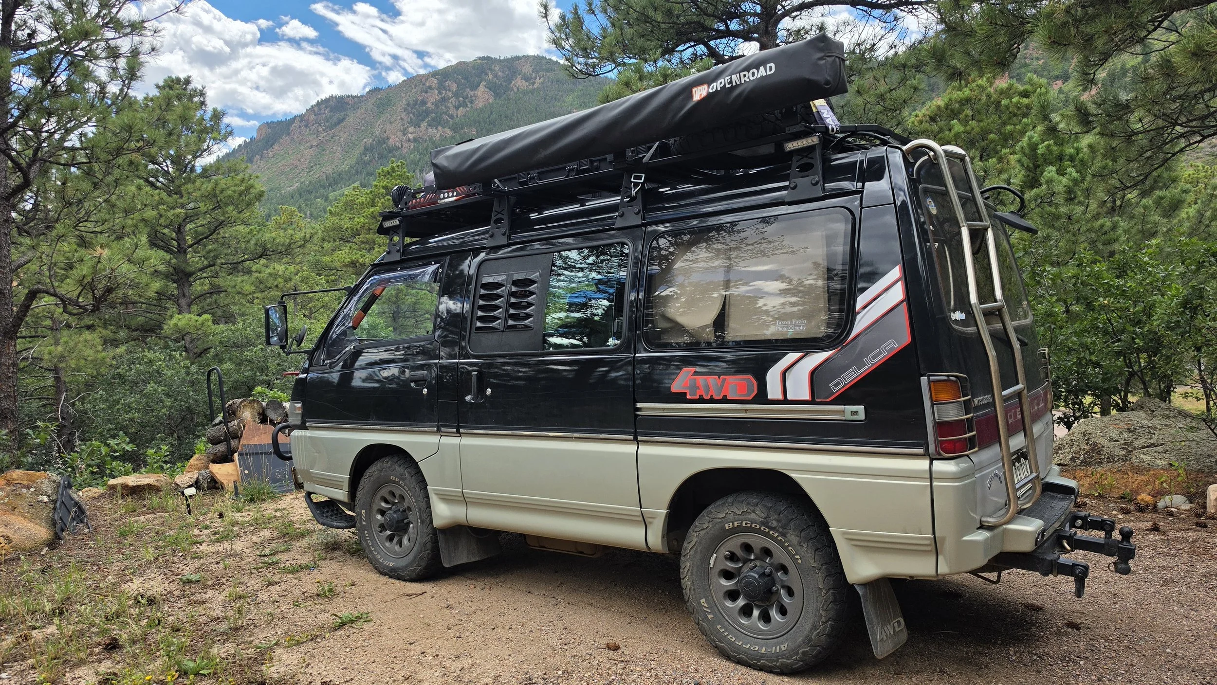 Mitsubishi Delica L300 fitted with screened window louvers that slip beneath the outer seals of the sliding windows.