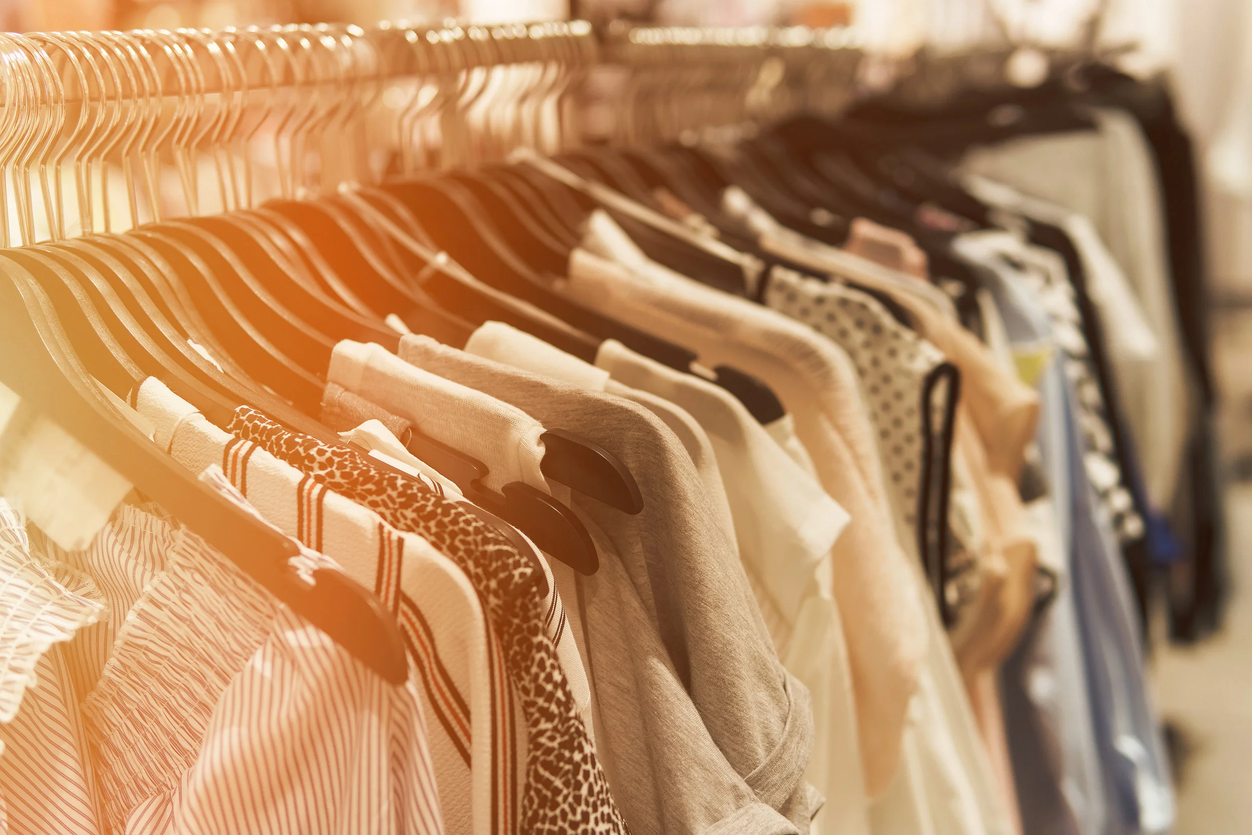 bigstock-Clothes-Hang-On-A-Shelf-In-A-D-200434999.jpg