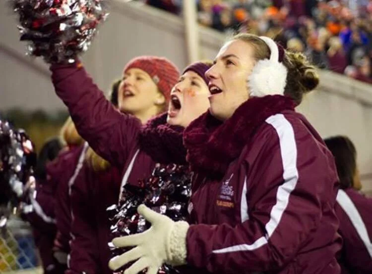 Members of the flag corps cheer our team on to victory, demonstrating what spirit is all about; Source: Facebook